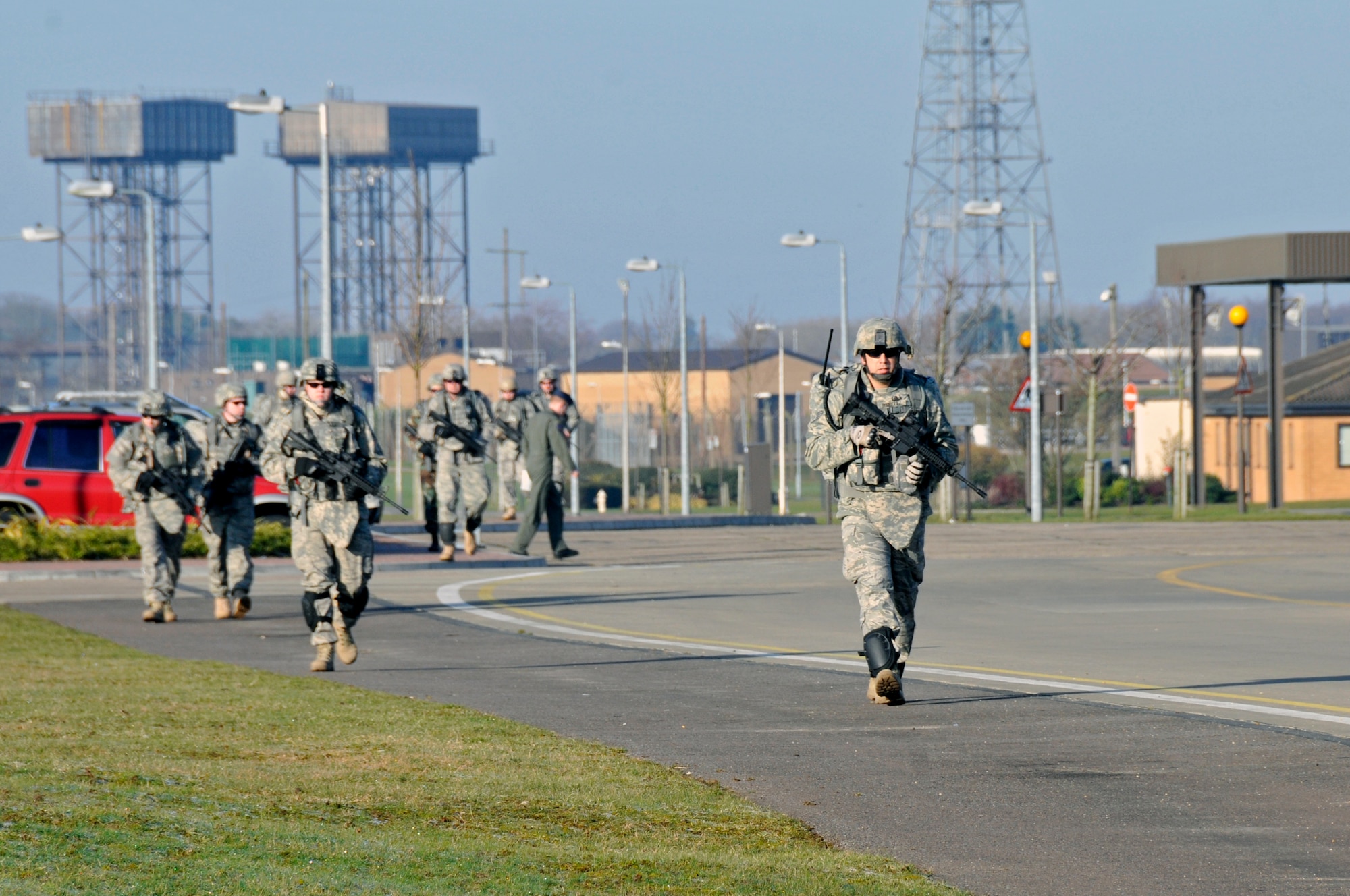 48th Civil Engineer Squadron explosive ordnance disposal team, march down Douglas Avenue to the Beckland Pines golf course where they will start their ground assault exercise March 6, 2009 at RAF Lakenheath, England. EOD Airmen marched seven miles around the perimeter of RAF lakenheath (U.S. Air Force photo by Airman 1st Class Perry Aston) 
