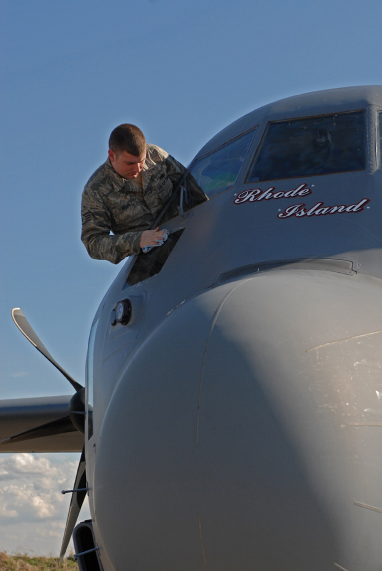Rhode Island Air National Guard Staff Sgt. Scott Selby, maintainer, washes the windows of a C-130J Super Hercules. The RIANG brought the C-130J aircraft to Bezmer Air Base, Bulgaria to train and conduct air crew qualifications for air crew and pilots, during Operation Thracian Spring, Bezmer Air Base, Bulgaria, March 9, 2009. Conducted annually since 2007, Operation Thracian Spring is a two week exercise allowing U.S. forces an opportunity to train and interact with their Bulgarian counterparts. (U.S. Air Force photo by Captain John Ross)