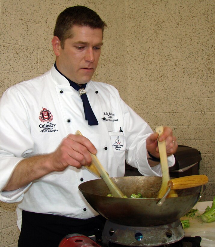 Kale Blackmon, certified culinarian with the Culinary Institute of Platt College, prepares a healthy vegetable stir-fry at the Women's Wellness Fair on Thursday, March 12. (U.S. Air Force photo by 2nd Lt. Lynn Aird)