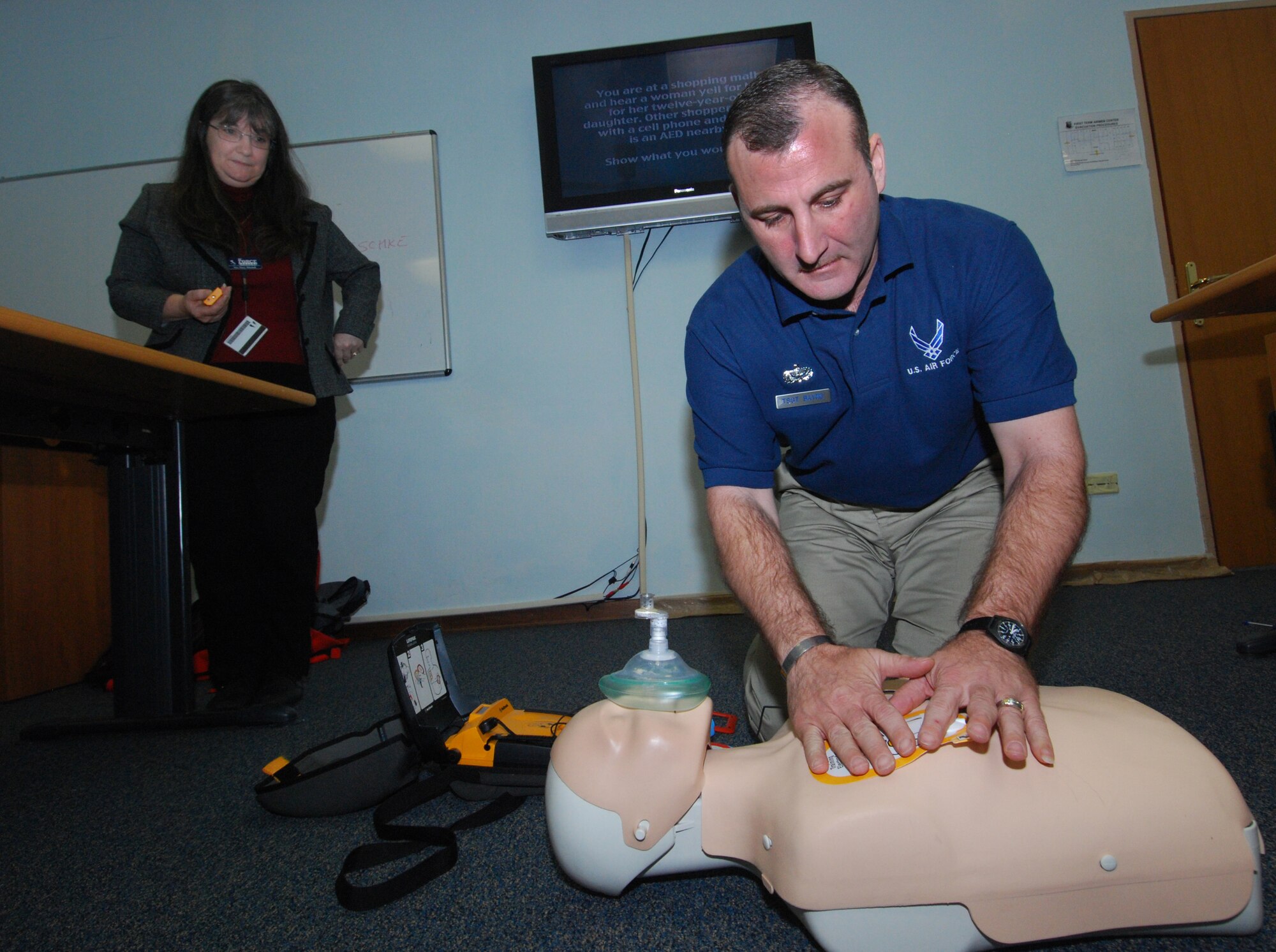 Technical Sgt. Wade Bayne, 31st Force Support Squadron, applies an automated external defibrillator electrodes pad to a "patient" during a CPR training course while CPR instructor Mary Mitchell, 31st FSS, observes. The pads allow the AED to examine the electrical output from the heart and determine if the patient is in a shockable rhythm. (U.S. Air Force photo/Staff Sgt. Justin Weaver)