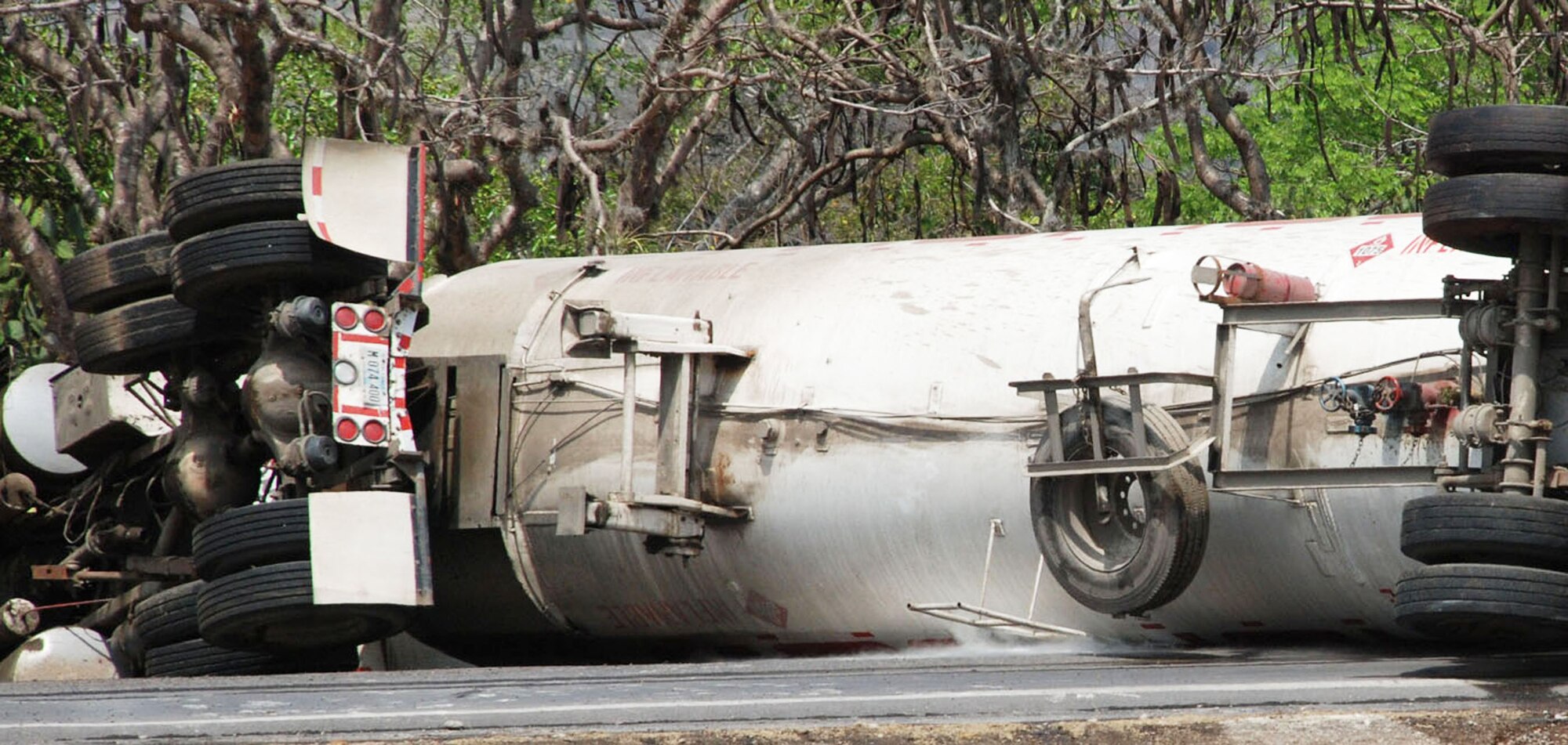 A leak in an overturned fuel tanker caused the closure a Honduran highway for more than 24 hours March 13 8 kilometers north of Soto Cano Air Base, Honduras. The truck overturned after hitting a horse on the road around 8 a.m. Joint Task Force-Bravo firefighters and medics responded to provide assistance to the Comayagua fire department. (U.S. Air Force photo/Tech. Sgt. Rebecca Danet) 
