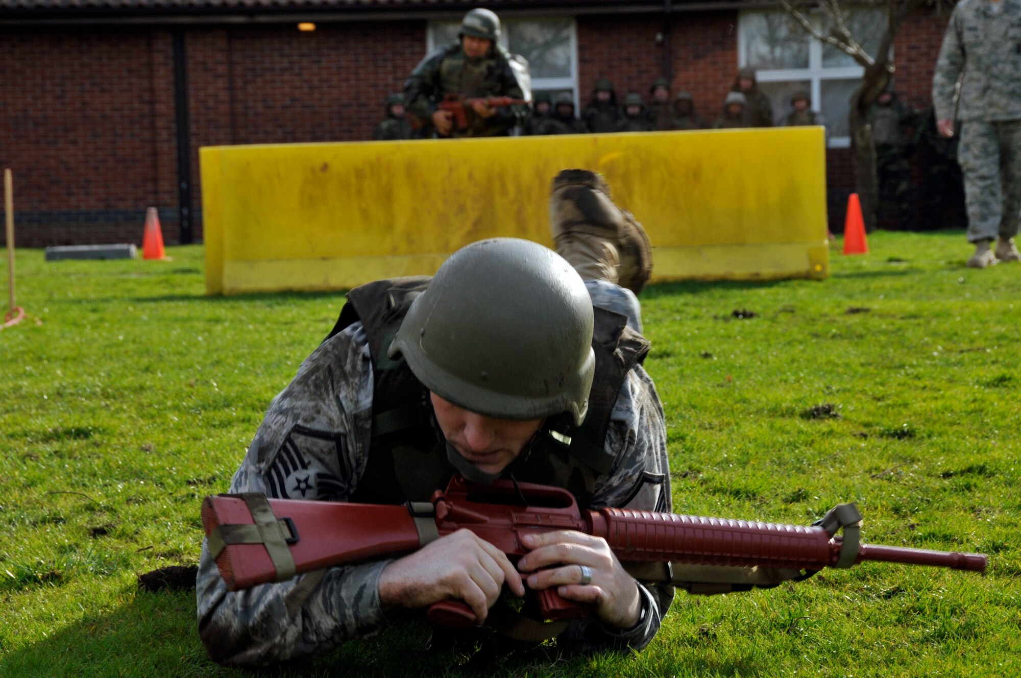 Master Sgt. Stephen Acker, 48th Operations Support Squadron intelligence flight, prepares to low crawl under barbed wire during expeditionary combat skills training March 4, 2009 at RAF Feltwell, England. Airmen are being trained by 48th Security Forces Airmen on tactics of integrated base defenses for future deployments. (U.S. Air Force photo by Airman 1st Class Perry Aston) 