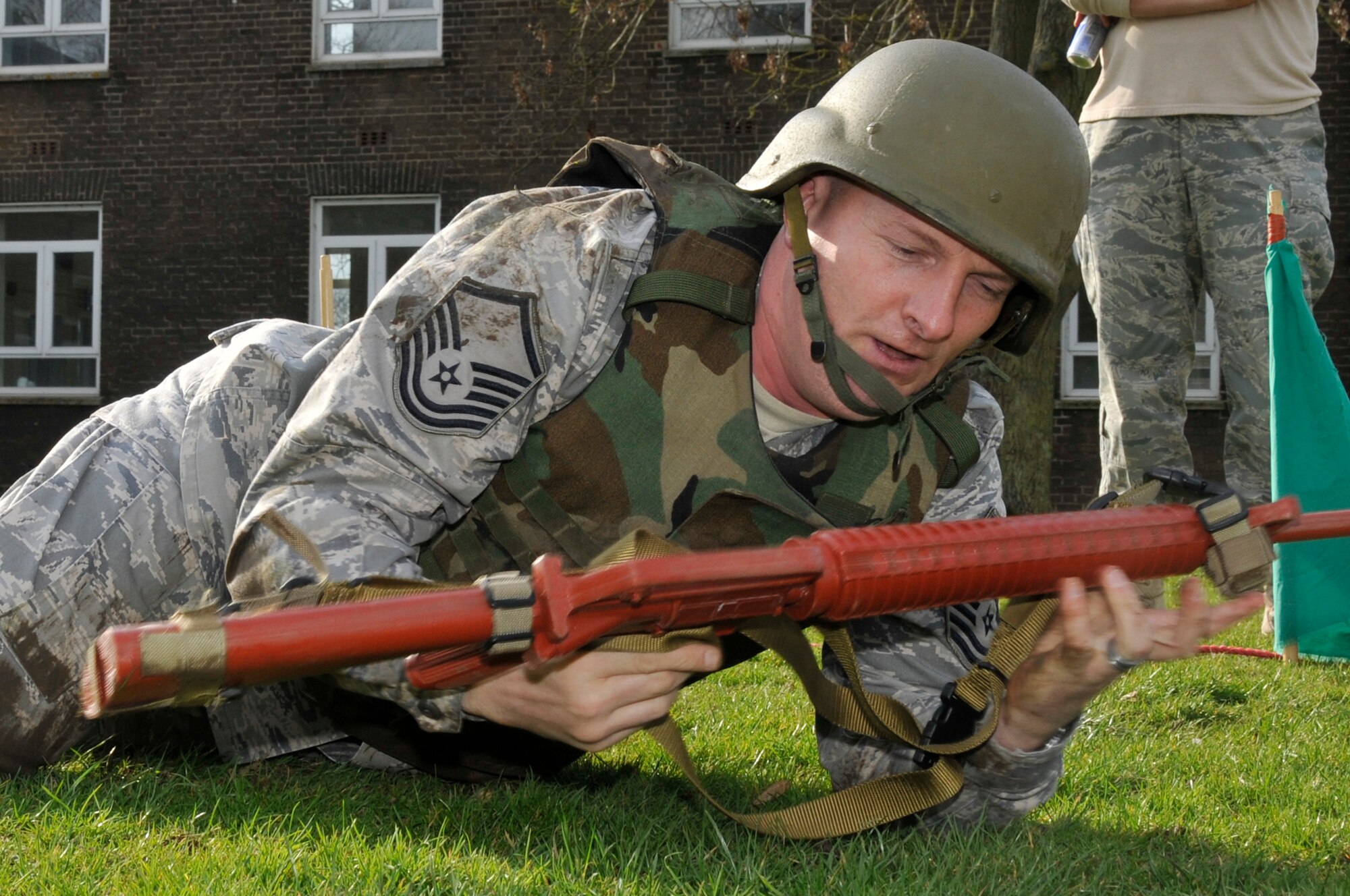 Master Sgt. Stephen Acker, 48th Operations Support Squadron intelligence flight, low crawls to the next obstacle during expeditionary combat skills training March 4, 2009 at RAF Feltwell, England. Airmen are being trained by 48th Security Forces Airmen on tactics of integrated base defenses for future deployments. (U.S. Air Force photo by Airman 1st Class Perry Aston)
