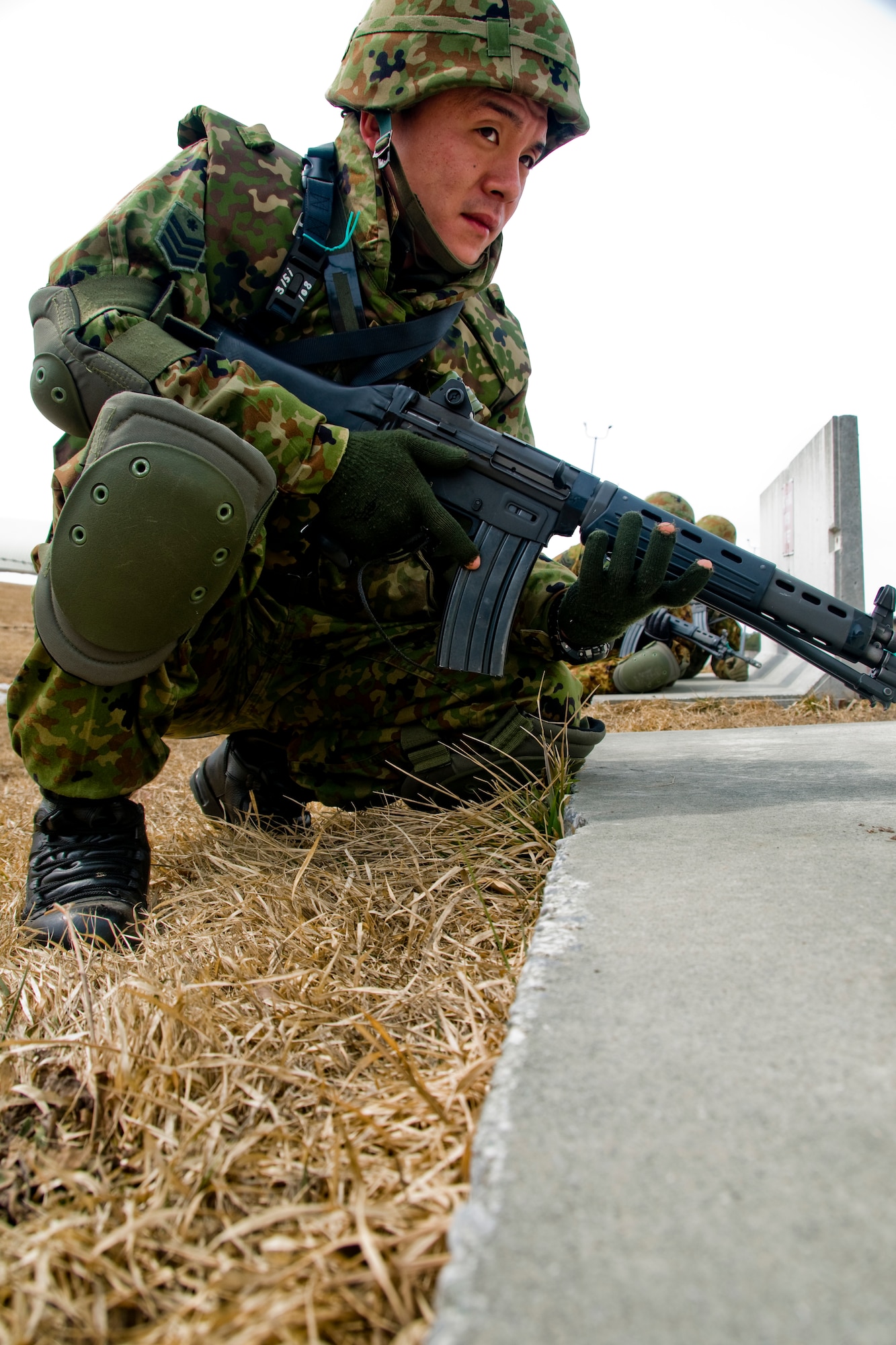 MISAWA AIR BASE, Japan -- A member of the Japan Ground Self-Defense Force, 9th Division, 5th Infantry Regiment, holds his position during an Exercise Guard and Protect scenario March 13, 2009. The exercise was to get Japanese forces familiar with the security roles they'd face when responding to an on-base incident. (U.S. Air Force photo by Senior Airman Jamal D. Sutter)
