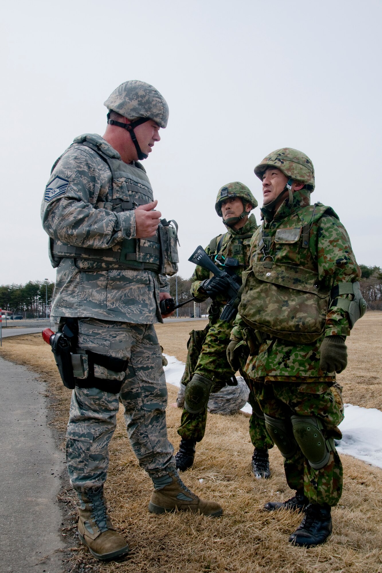 MISAWA AIR BASE, Japan -- Master Sgt. Robert Loughmiller, 35th Security Forces Squadron, discusses tactics with Master Sgt. Masato Hagaki, Japan Ground Self-Defense Force, and 2nd Lt. Fumiko Aizu, JGSDF, during Exercise Guard and Protect March 13, 2009. The 24-hour exercise assessed the U.S. and Japanese forces' ability to combine and protect the installation, base population and warfighting assets. (U.S. Air Force photo by Staff Sgt. Rachel Martinez)