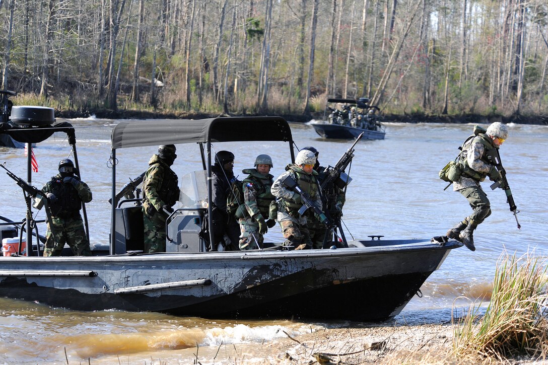 Students from the Patrol Craft Officer course at the Naval Small Craft Instruction and Technical Training School insert students from the Western Hemisphere Institute for Security Cooperation during a field training exercise, Stennis Space Center, Miss., March 4, 2009.