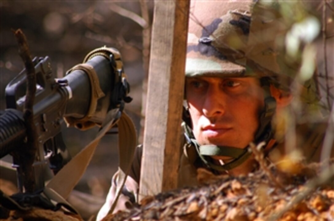 U.S. Navy Petty Officer 1st Class Dennis Tadlock, assigned to Naval Mobile Construction Battalion 1, keeps watch of the camp perimeter from a fighting position at Camp Shelby, Miss., on March 10, 2009.  More than 200 Seabees, most new to the battalion, are participating in Operation Winter Talon, a field exercise that will test their combat and contingency construction capabilities in a field environment.  
