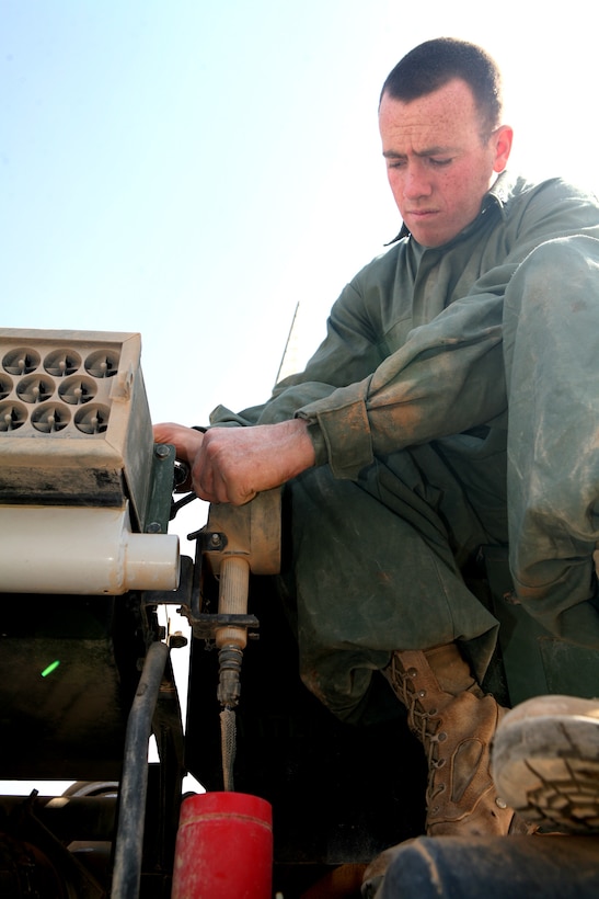 Replacing an air filter on a Logistics Vehicle System, Cpl. Matthew Adams, LVS operator, 1st Light Armor Reconnaissance Battalion, Regimental Combat Team 8, ensures his vehicle is ready for the next resupply mission.  Operators and mechanics continuously work on their vehicles to keep them ready for the next mission.
