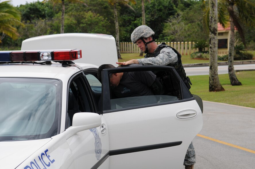 ANDERSEN AIR FORCE BASE, Guam – Senior Airman Alexander Nastas, 36th Security Forces Squadron, apprehends a suspect during Exercise Beverly Palm 09-03 March 18. In the exercise scenario, the suspect attempted to detonate a vehicle borne explosive device but was stopped by security forces personnel at the front gate.  Exercise Beverly Palm 09-03 is designed to evaluate the 36th Wing's ability transition from peacetime readiness to a wartime posture.  (US Air Force photo by Tech. Sgt. Michael Boquette)