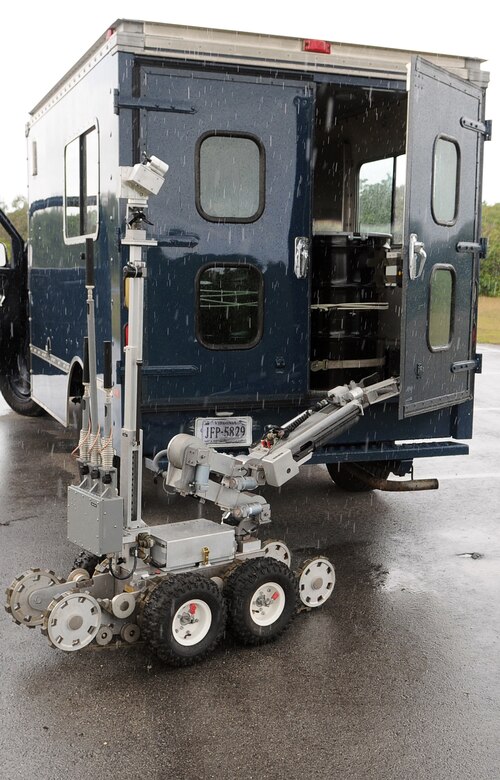 ANDERSEN AIR FORCE BASE, Guam – The F-6A Explosive Ordinance Disposal robot opens the rear door of a possible vehicle borne explosive device during Exercise Beverly Palm 09-03 March 18 here. The robot is operated remotely by an explosive ordnance disposal technician located a safe distance from the potential blast. (US Air Force photo by Tech. Sgt. Michael Boquette)