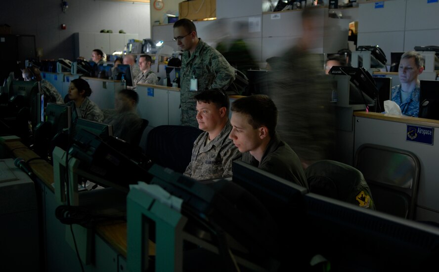 OSAN AIR BASE, Republic of Korea --  Military members at the Hardened Tactical Air Component Command operations floor at Osan AB, Korea,  keep a watchful eye on simulated friendly and enemy air and ground forces during Exercise Key Resolve/Foal Eagle 09. Through a series of computer networks and giant data walls, a joint team of Americans and Republic of Korea Air Force counterparts exercise their warfighting capabilities. The annual air and space portion of Key Resolve/Foal Eagle demonstrates U.S. resolve to support the Republic of Korea against external aggression while improving ROK-U.S. combat readiness and joint/combined interoperability. (U.S. Air Force photo by Staff Sgt. Benjamin Rojek)