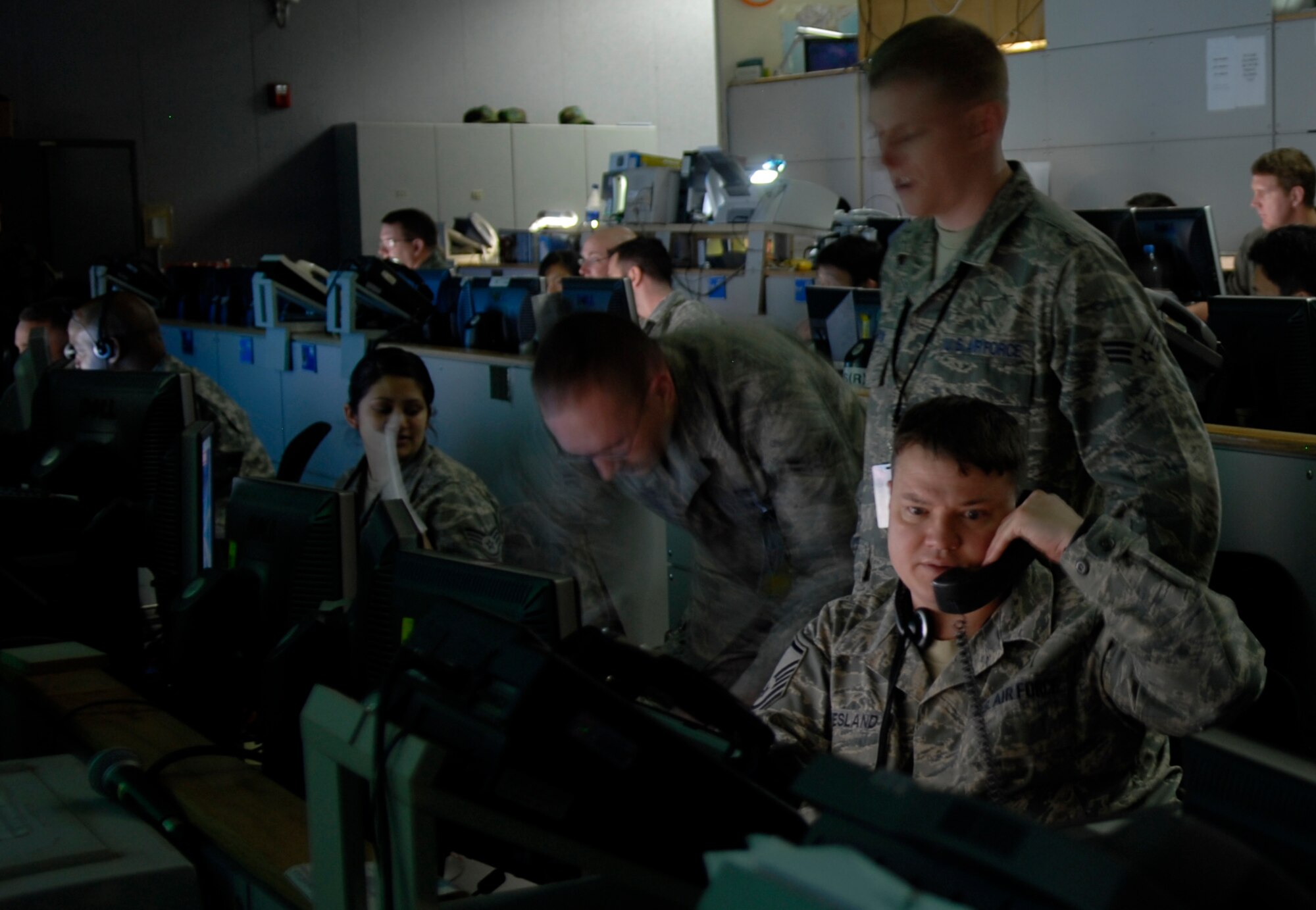 Military members at the Hardened Tactical Air Component Command operations floor at Osan AB, Korea,  keep a watchful eye on simulated friendly and enemy air and ground forces during Exercise Key Resolve/Foal Eagle 09. Through a series of computer networks and giant data walls, a joint team of Americans and Republic of Korea Air Force counterparts exercise their warfighting capabilities. The annual air and space portion of Key Resolve/Foal Eagle demonstrates U.S. resolve to support the Republic of Korea against external aggression while improving ROK-U.S. combat readiness and joint/combined interoperability. (U.S. Air Force photo by Staff Sgt. Benjamin Rojek)