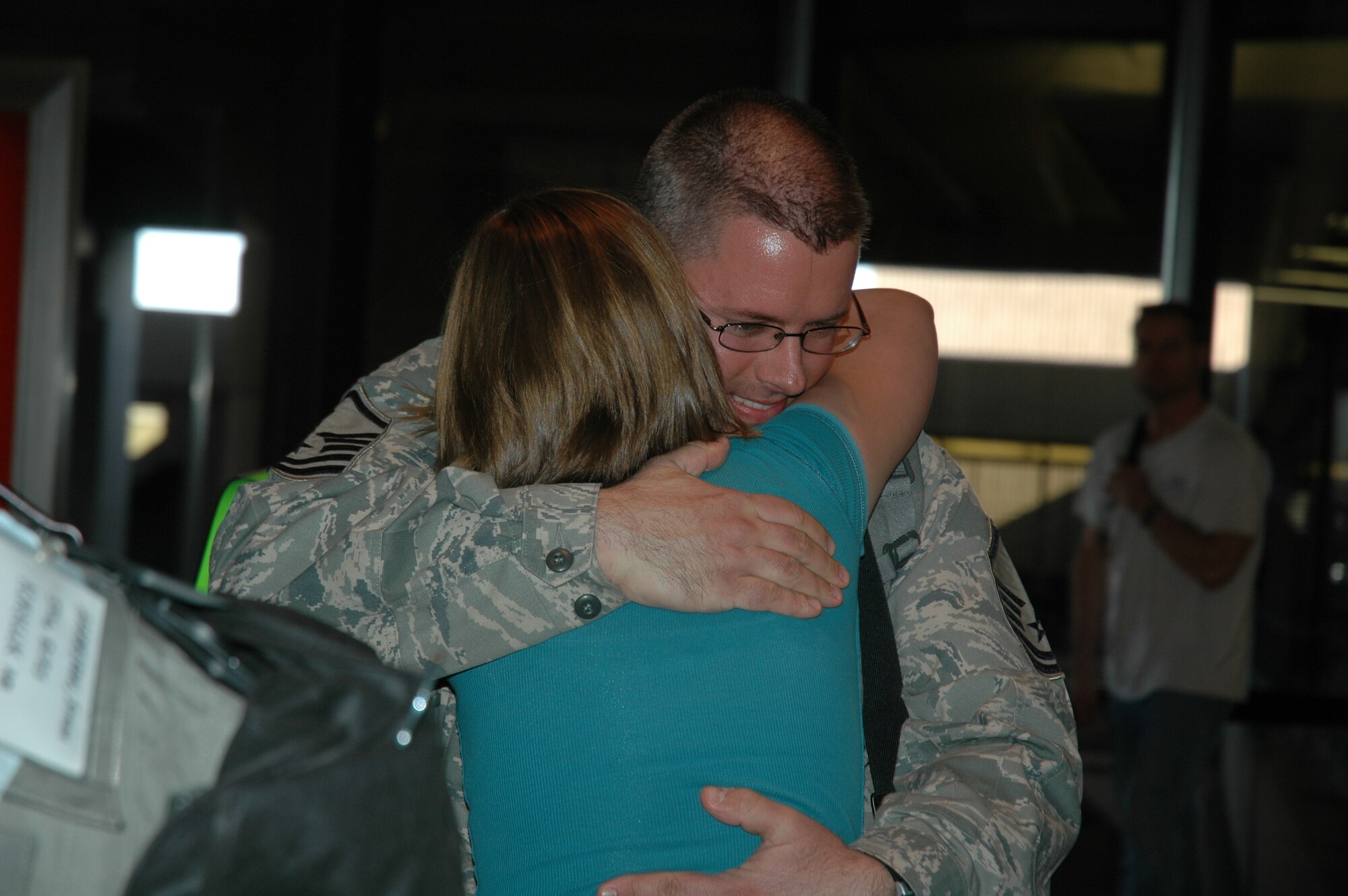 Master Sgt. David Drayovitch, 944th Civil Engineer Squadron HVAC superintendent, is greeted by his family March 17 at Phoenix Sky Harbor International Airport after returning from a deployment at Kirkuk Regional Air Base, Iraq. Sergeant Drayovitch, along with 23 other reservists from the 944th CES, spent six months away from their families and civilian jobs in support of the Global War on Terrorism. (U.S. Air Force photo/Tech. Sgt. Susan Stout)