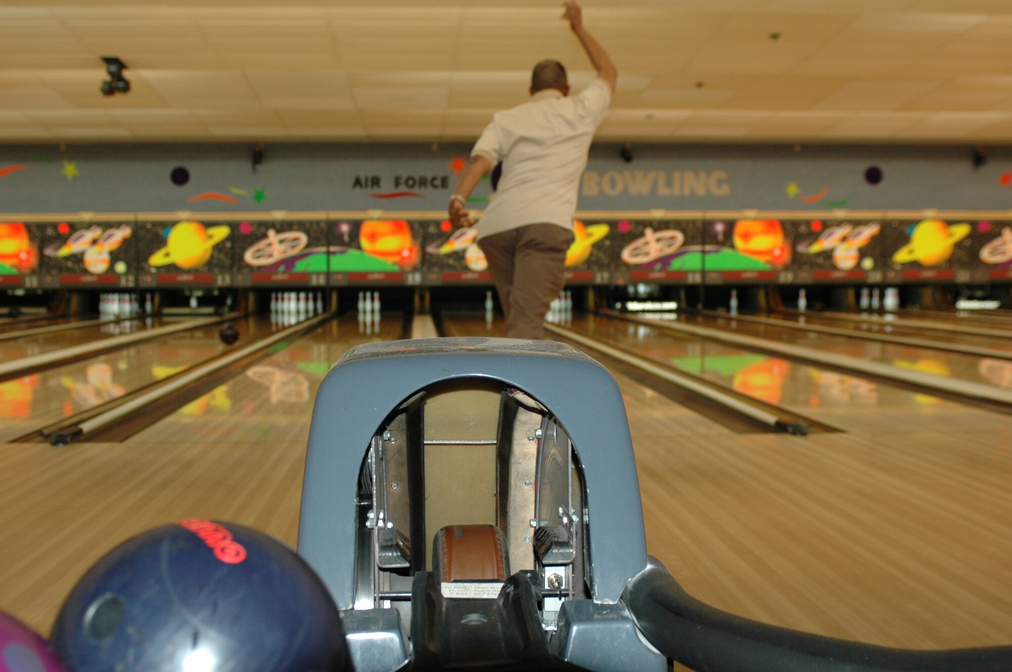 Herb Lewis finishes a toss March 16 on lane No. 16 at the Travis Bowling Center. Mr. Lewis and friends compete in a senior league held each winter from Labor Day through the end of April for bowlers age 55 and older. (U.S. Air Force photo/Nick DeCicco)