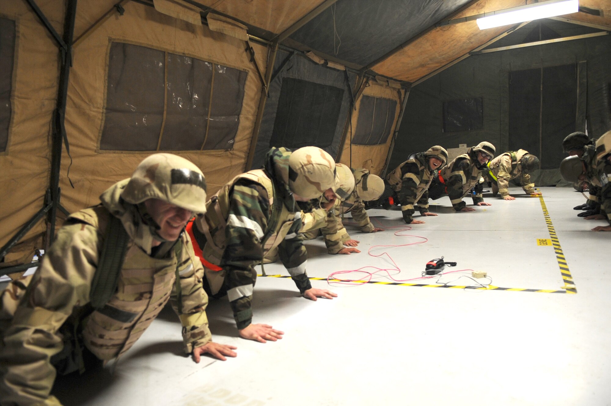 Members of 319th Maintenance Squadron push out push-ups for Chief Master Sgt. Martin Weglarez, 319th Maintenance Group superintendent,while donned in mission oriented protective posture two. The chief joined the team in the push ups, daring anyone to do more than him.
(Photo/Staff Sgt. Suellyn Nuckolls)
