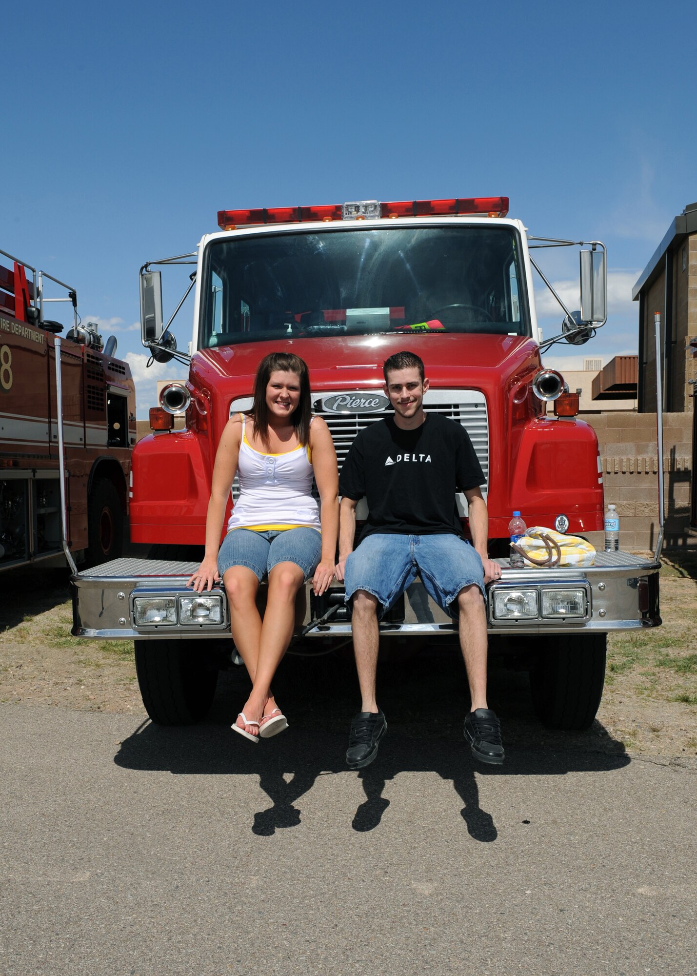 Air Force spouse Dackory Dowdle and friend  Kristta Backus pose for a picture on one of the fire truck displays during the 16th annual D-M 50 picnic at Bama Park March 13. The D-M 50 hosts the picnic for D-M personnel and their families with free entertainment and food. (U.S. Air Force photo/Airman 1st Class Brittany Dowdle)
