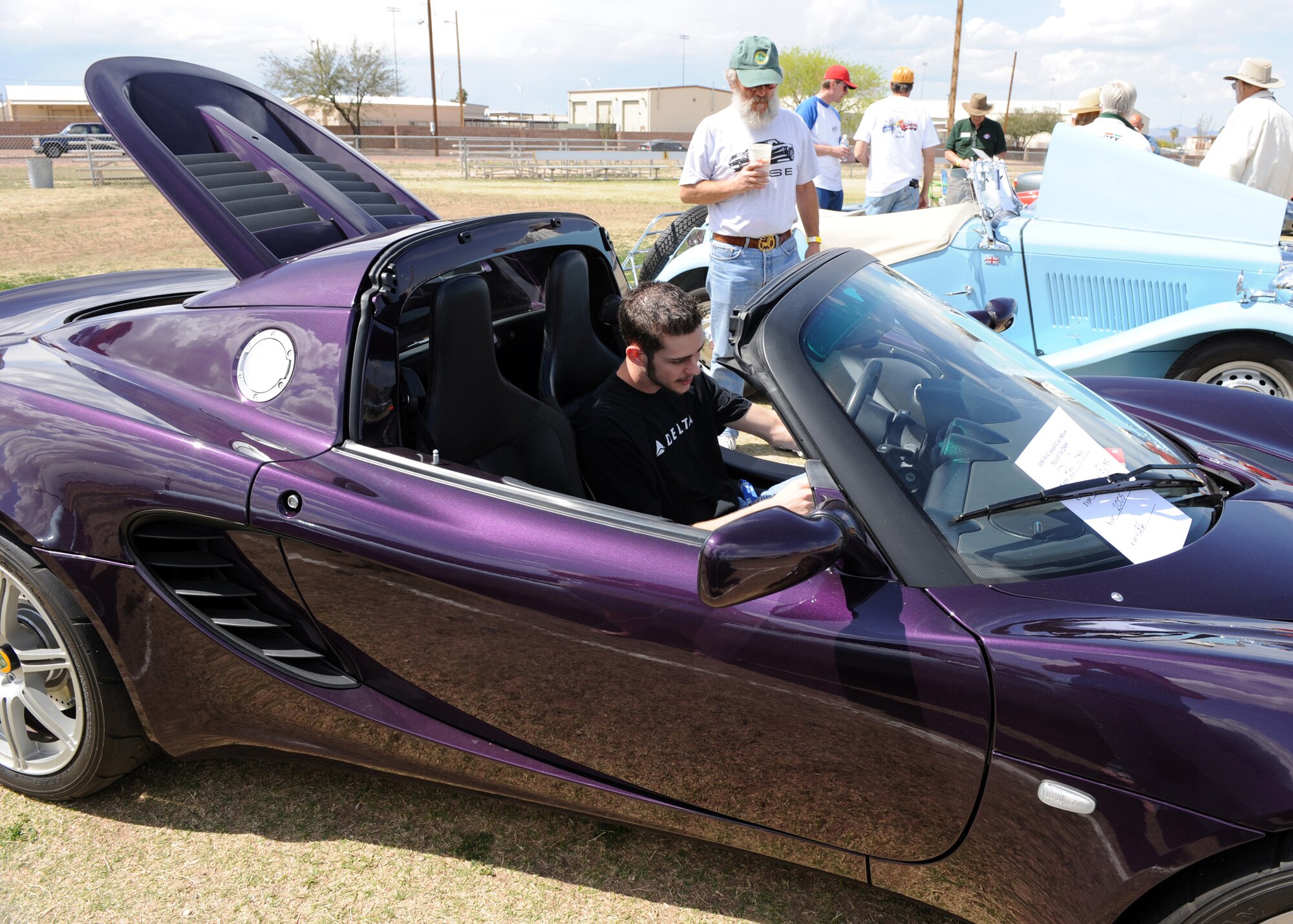 Cohen lets Dackory Dowdle, an Air Force spouse sit in his 2005 Lotus Elise at a car show that was part of the 16th annual D-M 50 picnic at Bama Park March 13. The D-M 50 hosts the picnic for D-M personnel and their families with free entertainment and food. (U.S. Air Force photo/Airman 1st Class Brittany Dowdle)
