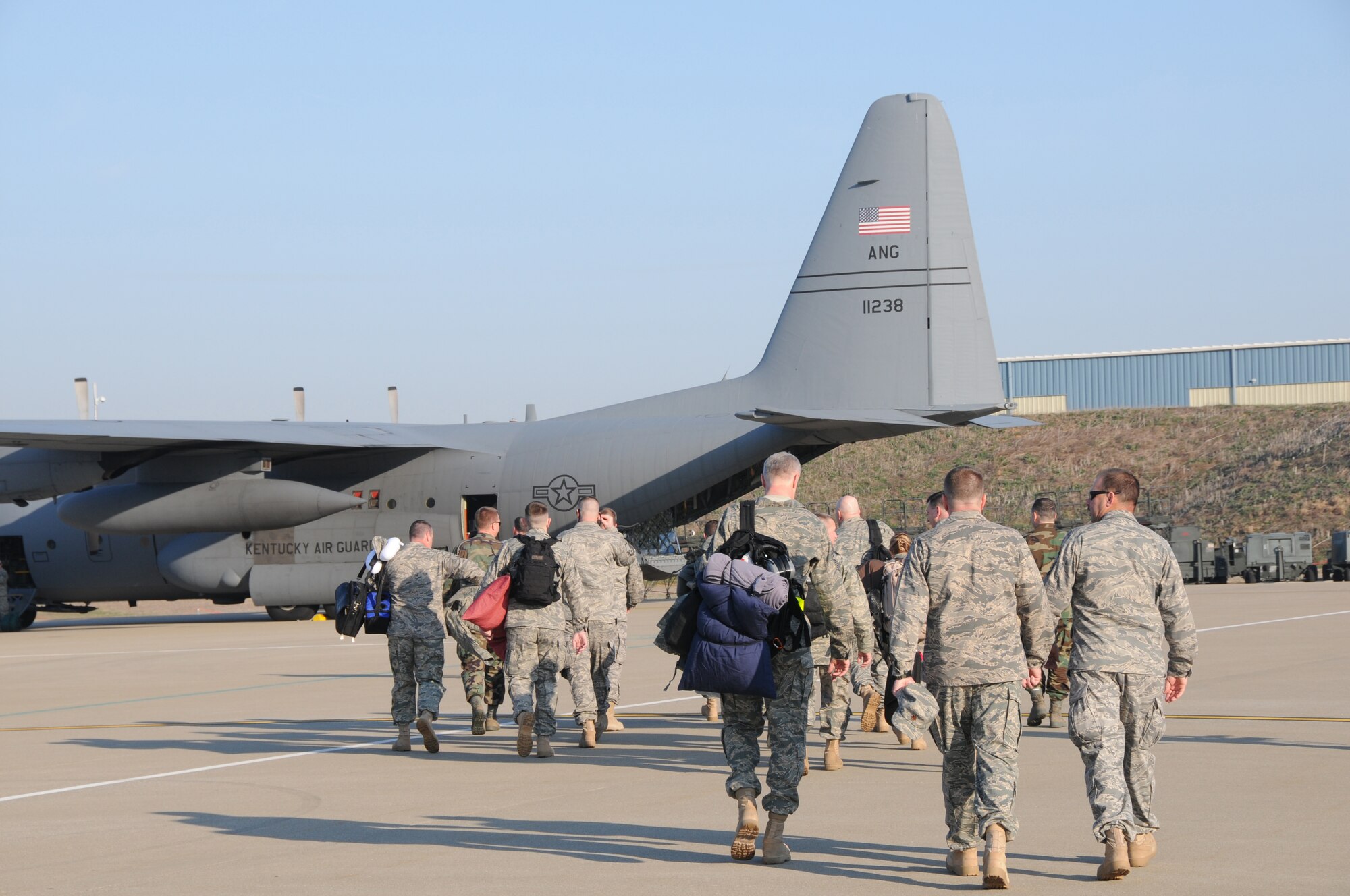 Air Guardsmen prepare to board a C-130 en route to Afghanistan on March 18 at the Kentucky Air National Guard Base in Louisville, Ky. The Airmen will be providing airlift services as part of Operation Enduring Freedom through May 19. (USAF photo by Tech. Sgt. Dennis Flora.)