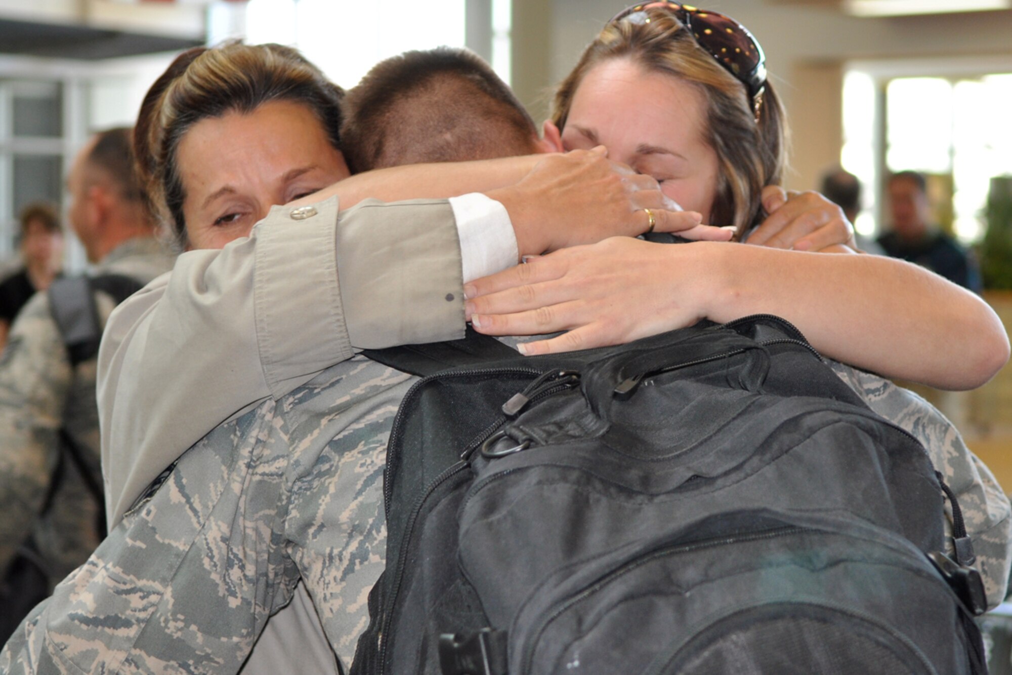 Senior Airman Jacob Weaver receives hugs and kisses from his family members upon arrival at the Shreveport Regional Airport March 17, 2009. Airman Weaver, a member of the 917th Civil Engineer Squadron at Barksdale Air Force Base, La., is part of a group of engineers who deployed to Kirkuk Regional Air Base, Iraq six months ago.  Approximately 120 family, friends and co-workers showed up to welcome home their local heroes.  (US Air Force photo/Tech. Sgt. Jeff Walston)
