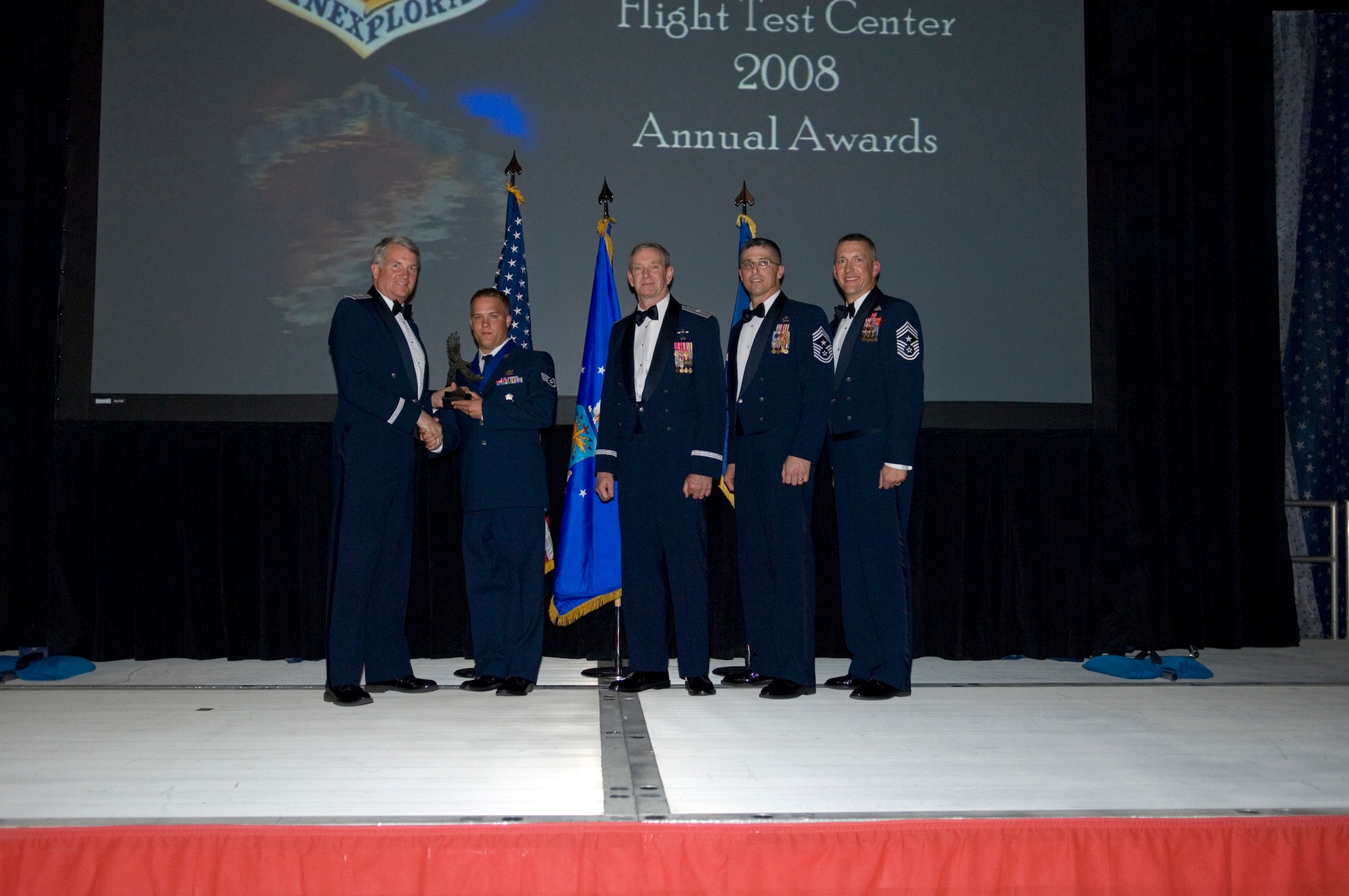 Staff Sgt. Joshua Lemburg (second from left), 95th Security Forces Squadron flight sergeant, received the Air Force Flight Test Center Noncommissioned Officer Reservist of the Year from Maj. Gen. David Eichhorn (left), AFFTC commander, during a ceremony at Hangar 1820 March 13. (U.S. Air Force photo/Mike Cassidy)