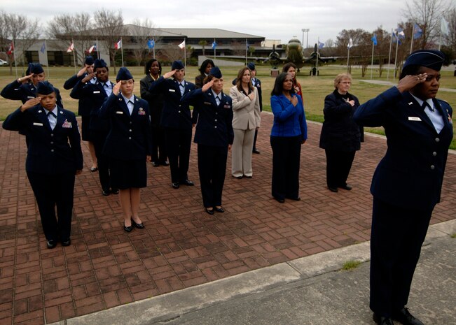 Female members of Team Charleston salute the flag during the all-women retreat  ceremony here March 13. Women's History Month was created to increase education and awareness on the countless achievements of women in America. (U.S. Air Force photo/Senior Airman Timothy Taylor)