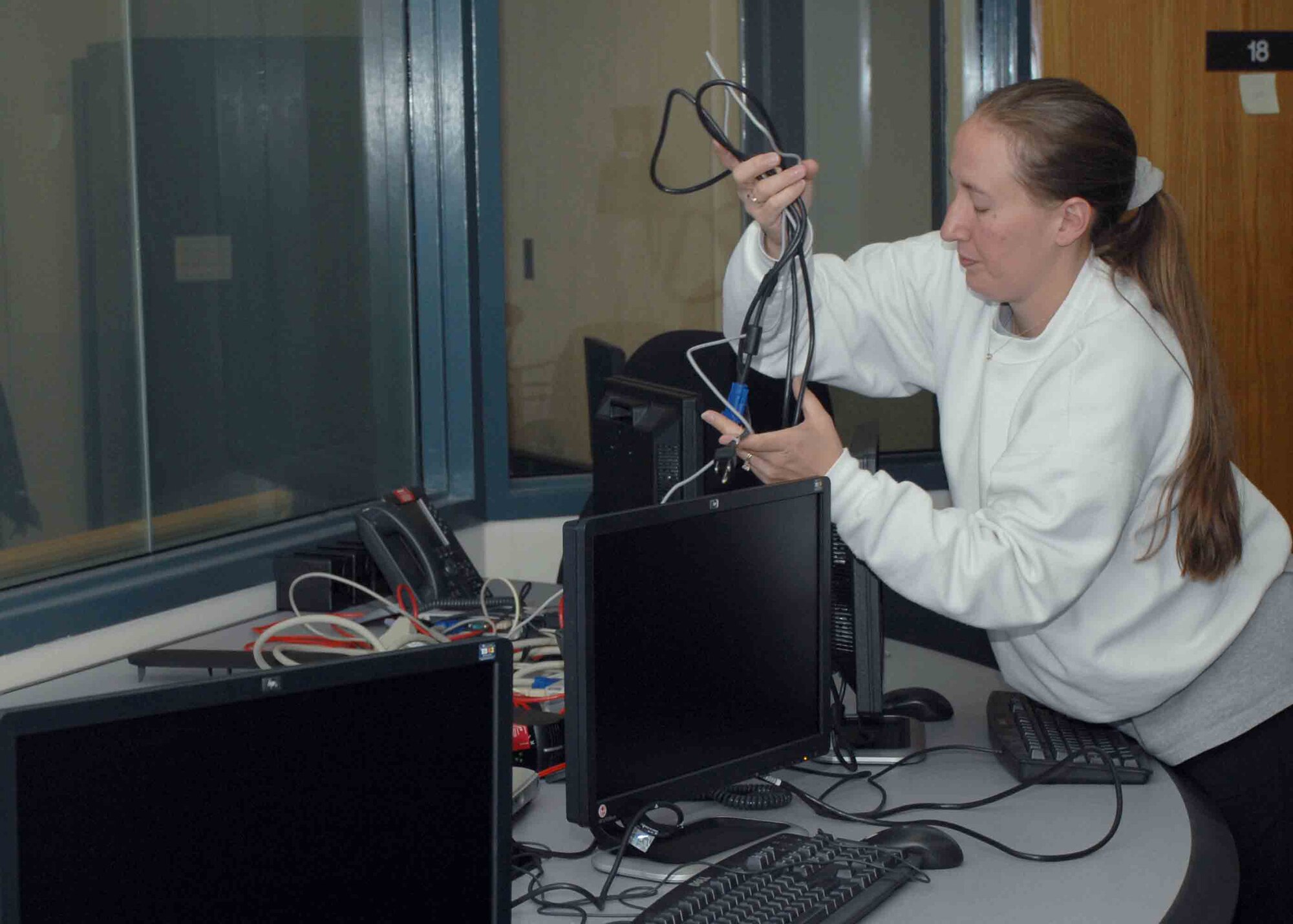 CANNON AIR FORCE BASE, N.M. -- Master Sgt. Bobbi Jo Stumpf, 27th Special Operations Wing Command Post, zip-ties together loose cords in one of the rooms of the recently renovated Command Post March 12. The command post was renovated to update the communications systems as well as other things. (U.S. Air Force photo/Airman 1st Class James Bell)