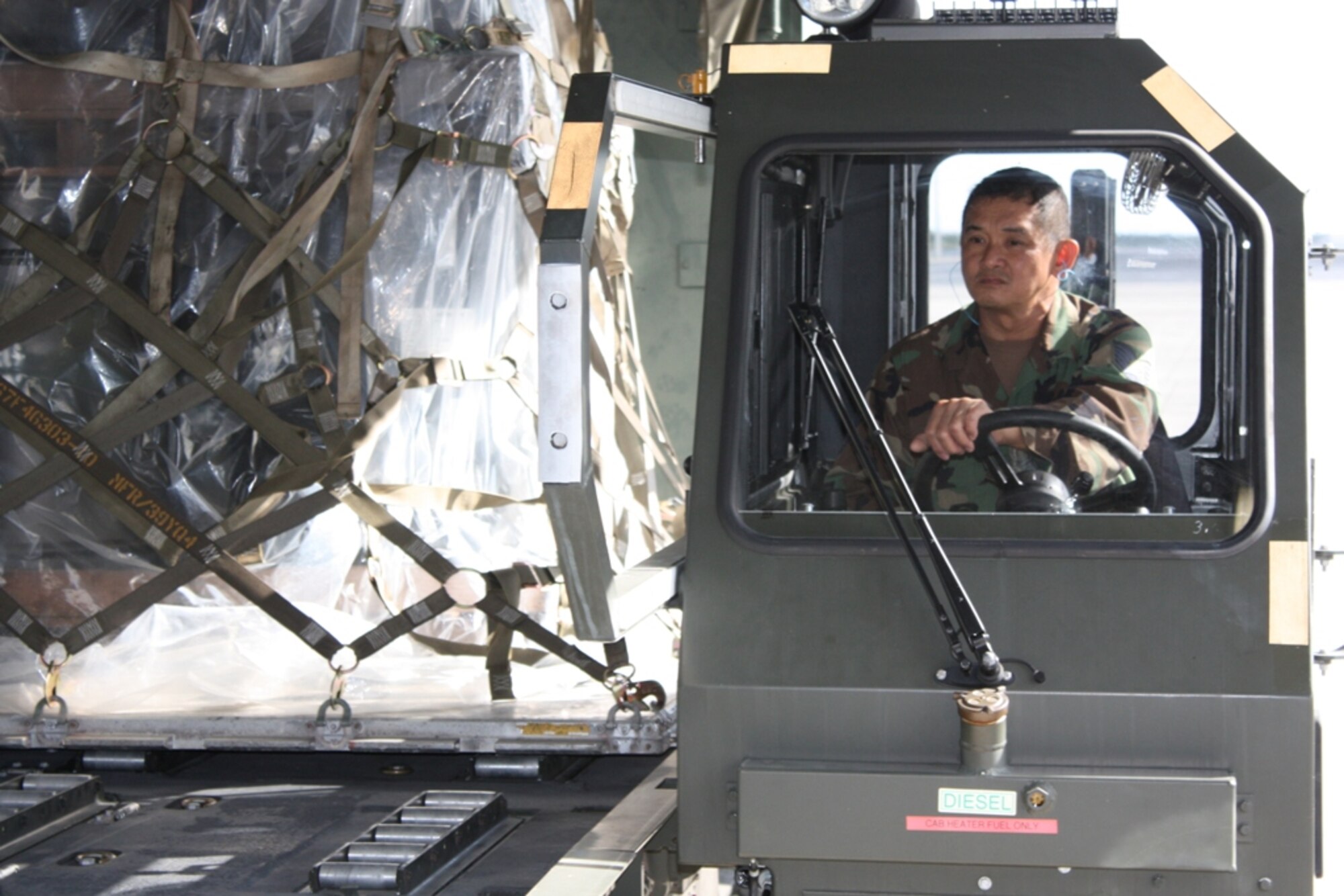 Tech. Sgt. Angelino Basi, 70th Aerial Port Squadron, drives a 25,000-pound loader up to a C-17 Globemaster during training during the March Unit Training Assembly. The C-17 was flown to Homestead to serve as a static trainer to prepare aerial porters for future deployments. A large contingent from the 70th APS is currently deployed to Kirkuk Regional Air Base, Iraq, where they are directly supporting U.S. and Coalition ground forces. There, the reservists are loading and unloading military transport aircraft, tracking supplies and equipment, and processing passengers traveling in and out of Iraq. (U.S. Air Force photo/2nd Lt. Erik Hofmeyer)
