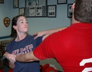 Senior Airman Kristina Andreozzi, 919th Maintenance Group, practices breaking a choke hold while simultaneously striking back on her "attacker" during a Krav Maga training class taught weekly at Duke Field. Krav Maga is a type of close-quarters combat training developed in Israel and used by Israeli Defense Forces as well as several U.S. government and law enforcement agencies. Rigorous training routines help students build greater cardio fitness, muscle strength and coordination, as well as provide strong self defense tactics for real world or combat situations. (U.S. Air Force photo / Master Sgt. Paul Morales)