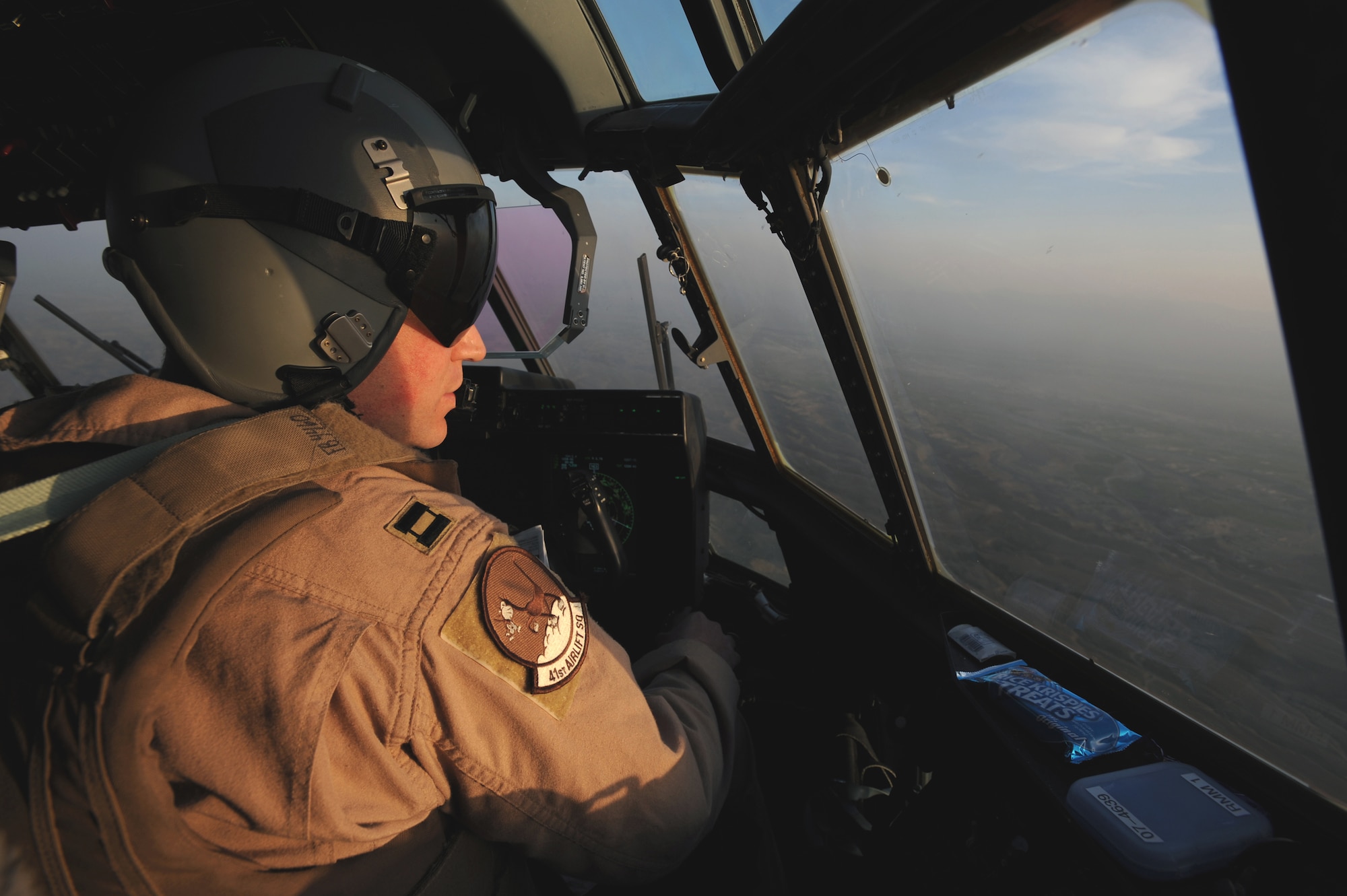 Captain Don Rolleg flies a C-130 Hercules mission March 14 over Afghanistan. He is assigned to the newly activated 772nd Expeditionary Airlift Squadron at Kandahar Airfield, Afghanistan, activated to assist with the increase of U.S. troops to the region. Captain Rolleg is a C-130 pilot. (U.S. Air Force photo/Staff Sgt. James L. Harper Jr.) 

