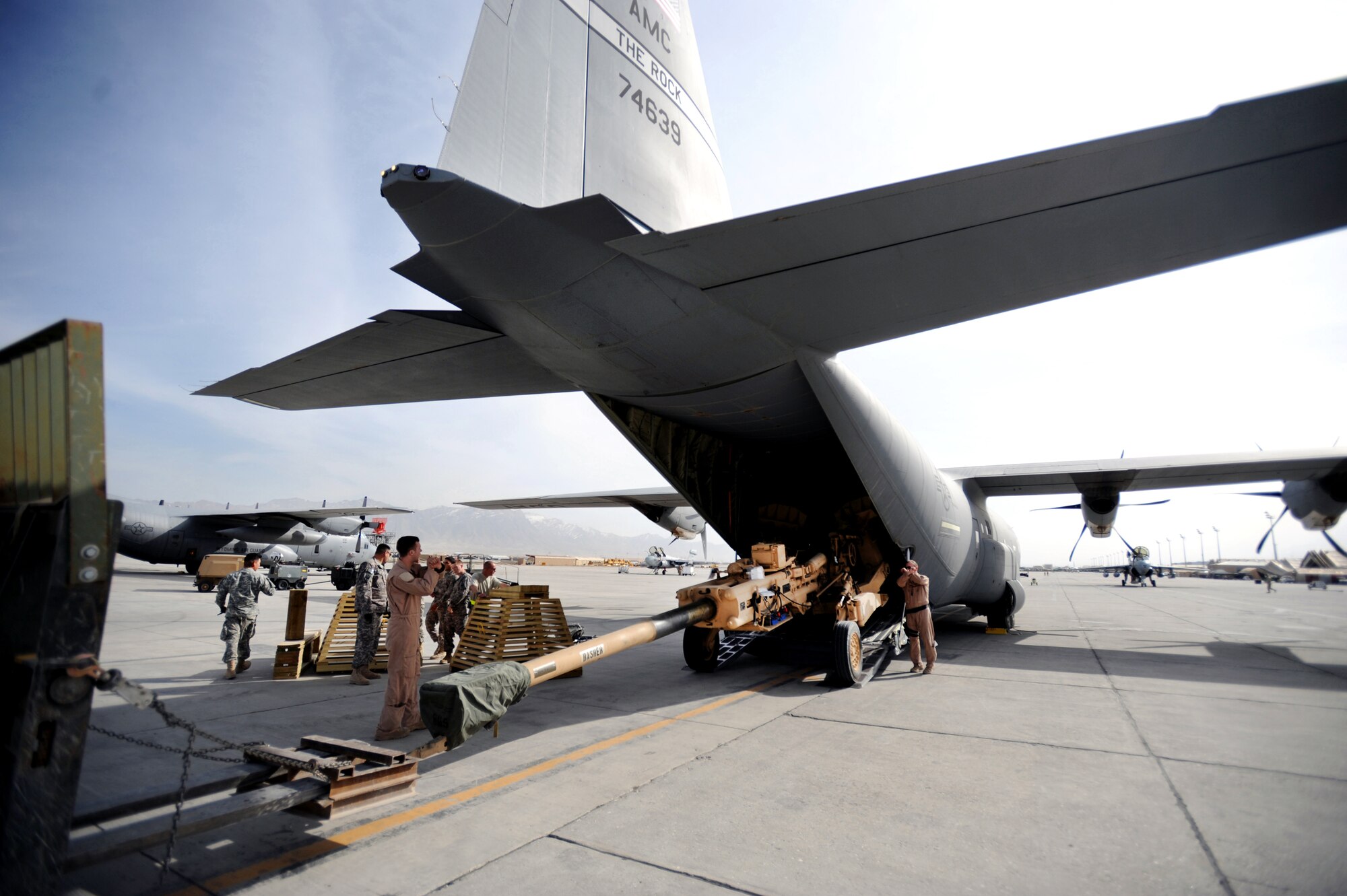 Aircrew members load an M777 A2 Howitzer onto a C-130J Hercules March 14 at Bagram Airfield, Afghanistan. The C-130J is part of the newly assigned 772nd Expeditionary Airlift Squadron at Kandahar Airfield, Afghanistan, that has been set up to assist with the increase of U.S. troops to the region. (U.S. Air Force photo/Staff Sgt. James L. Harper Jr.) 

