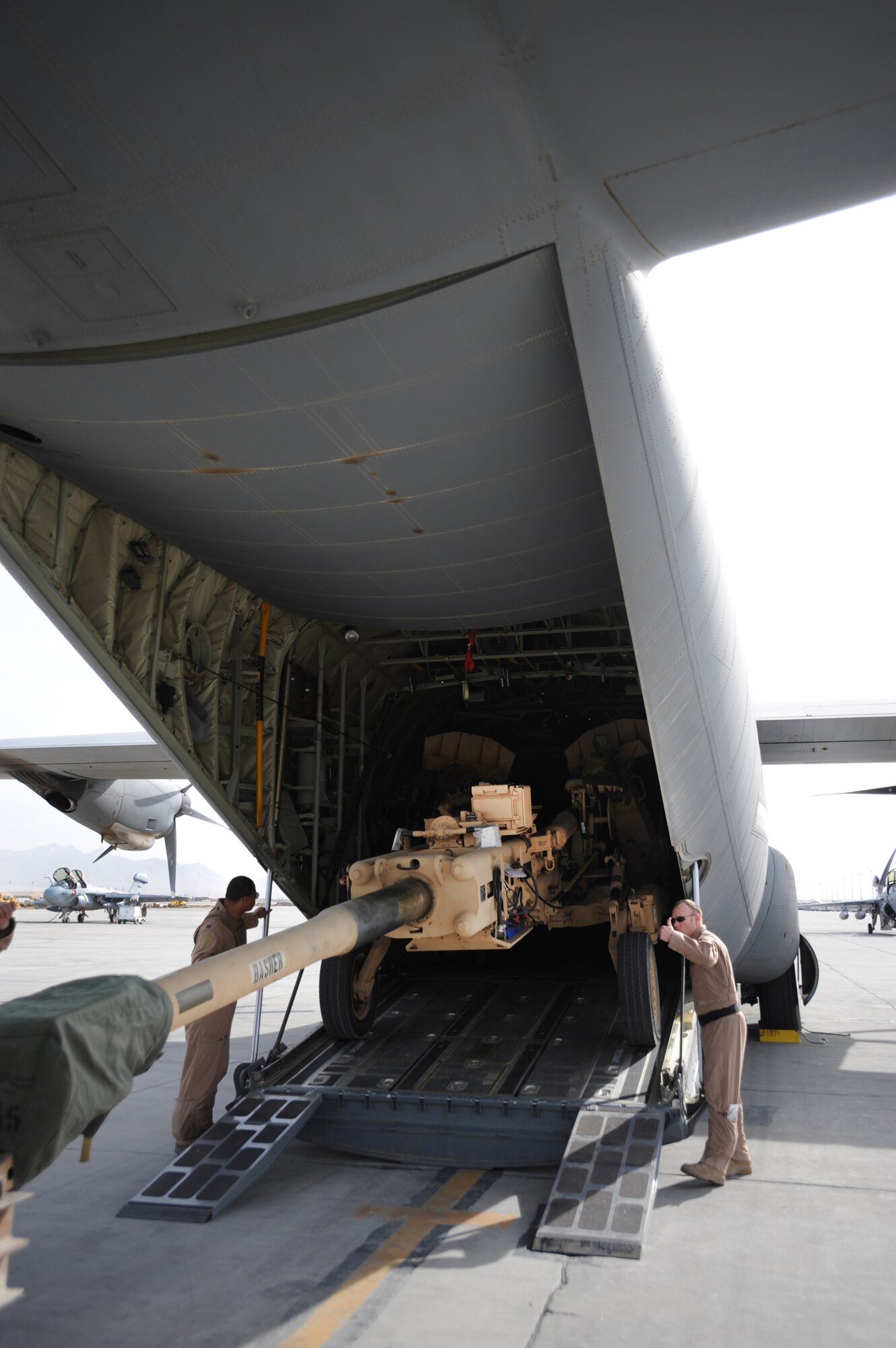 Aircrew members load an M777 A2 Howitzer onto a C-130J Hercules March 14 at Bagram Airfield, Afghanistan. The C-130J is part of the newly assigned 772nd Expeditionary Airlift Squadron at Kandahar Airfield, Afghanistan, that has been set up to assist with the increase of U.S. troops to the region. (U.S. Air Force photo/Staff Sgt. James L. Harper Jr.) 
