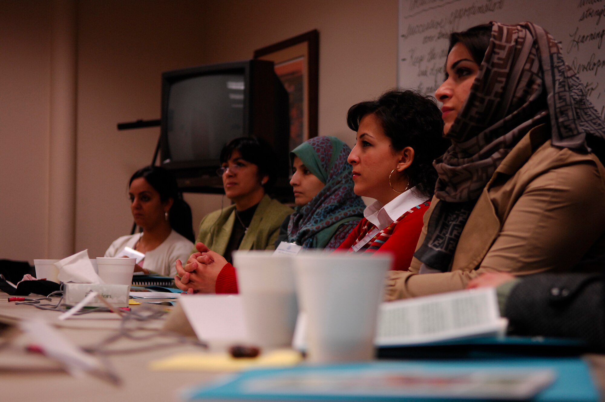 MINOT AIR FORCE BASE, N.D. -- A group of Middle Eastern and African women, all emerging leaders in the areas of social work, law and business in their respective countries, listen to various local speakers during a discussion panel at the North Central Human Services conference room here March 13. The panel was part of the International Visitor Leadership Program of the U. S. State Dept. Bureau of educational and Cultural Affairs, which coordinates local programs for international visitors from a variety of countries and areas of interest. (U.S. Air Force photo by Staff Sgt. Thomas Dow)