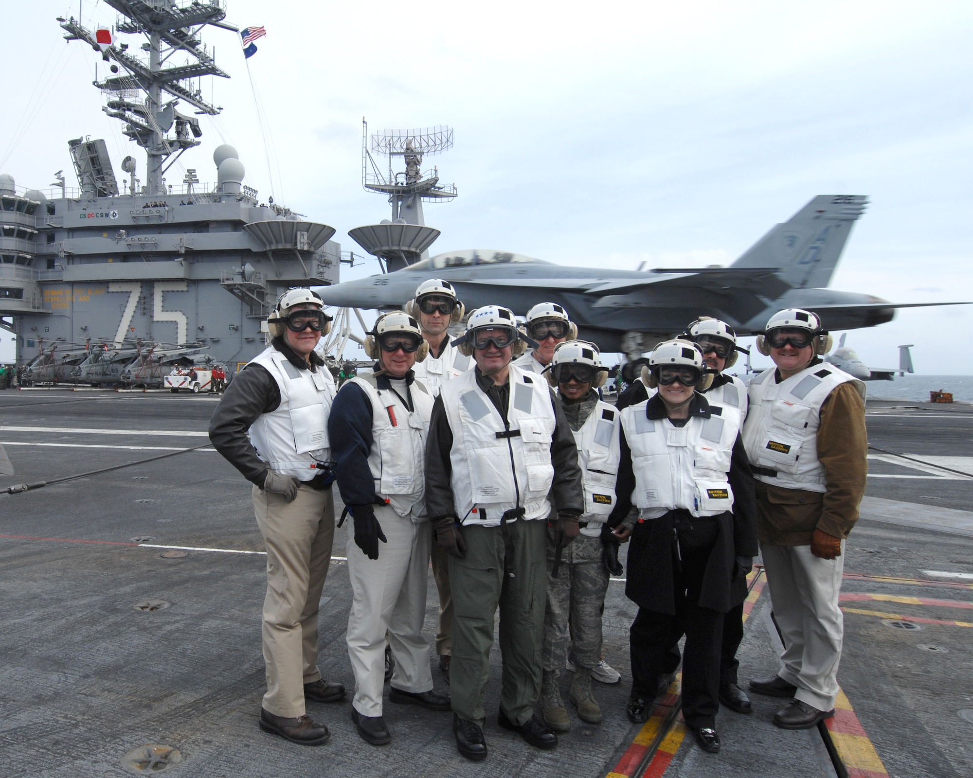 USS HARRY S. TRUMAN - A group of area civic leaders, hosted by United States Transportation Command Commander Gen. Duncan J. McNabb, center, in flight suit, pose for a picture, last week, on the flight deck of the USS Harry S. Truman at Naval Station Norfolk.  Guests included Gen. Duane Cassidy, Doug King, president and CEO of the St. Louis Science Center and Chairman of the St. Clair County Board Mark Kern.  The group, accompanied by St. Louis area media, also toured a Military Sealift Command large, medium-speed, roll-on/roll-off ship, and other community relations oriented activities. The trip was organized to demonstrate USTRANSCOM’s working relationship with its customers.