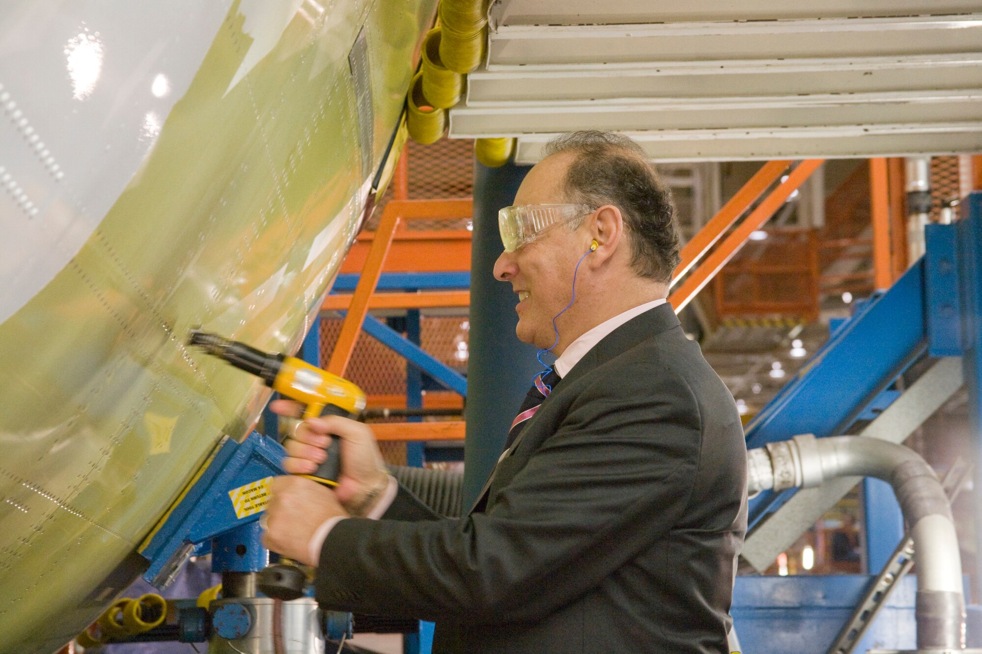 Hungarian Minister of Defense Dr. Imre Szekeres drives a ceremonial rivet into the airframe of the first C-17 the 12-nation Strategic Airlift Capability consortium will receive this summer.  The Republic of Hungary played a  significant role in the "major join" ceremony of the C-17 given the country has provided Papa Air Base as the SAC program's main operating base and will serve as the flag nation in registering the SAC aircraft. (Courtesy photo)