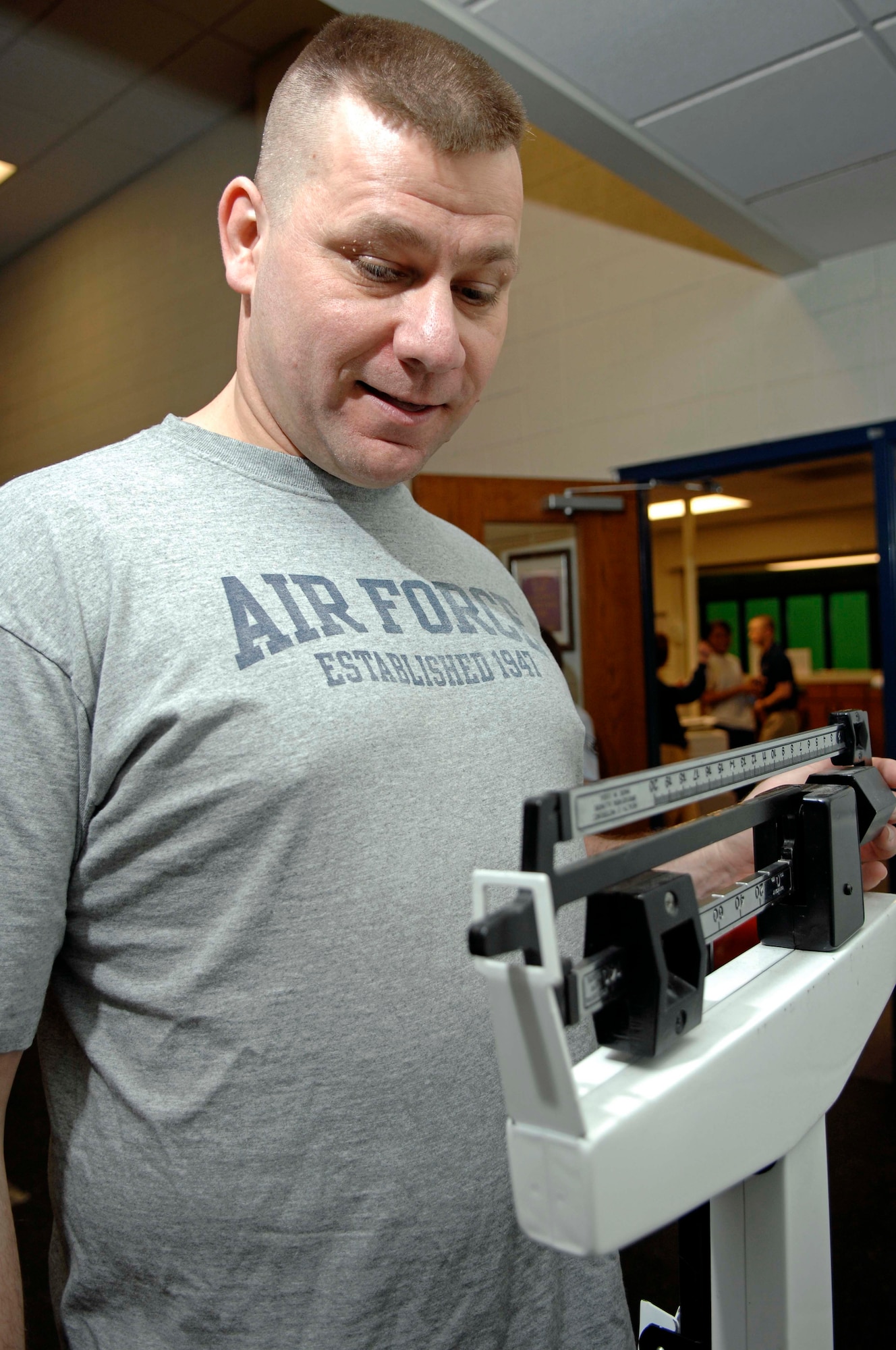Staff Sgt. Kevin Pike, 28th Bomb Wing chaplain assistant, carefully weighs himself during the final weigh-in for the Bellamy Fitness Center's "Biggest Loser" competition, March 10. Sergeant Pike competed against 70 other participants to win the title of the fitness center's "Biggest Loser." (U.S. Air Force photo/Airman 1st Class Abigail Klein)