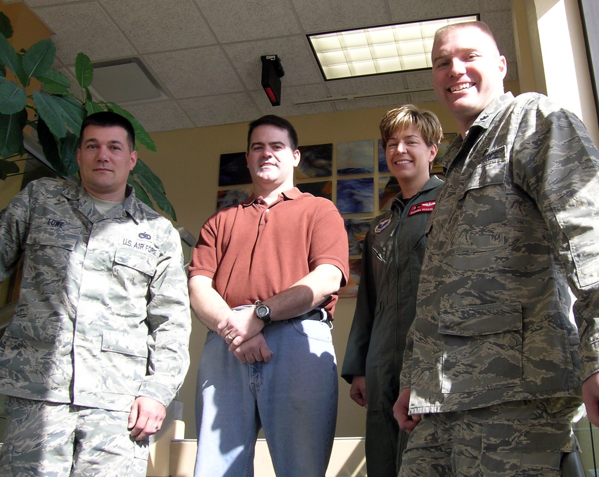 The Healthy Hicks team, from left, Tech. Sgt. Shane Lowe, Mike DeGarmo, Maj. Karrina DeGarmo and Lt. Col. Darin Gibbs, placed first at the second weigh in for the Vance Biggest Losers weight-loss competition March 6. They lost a total of 32.4 pounds, 4.12 percent of their body weight. (U.S. Air Force photo by Melissa Seror)