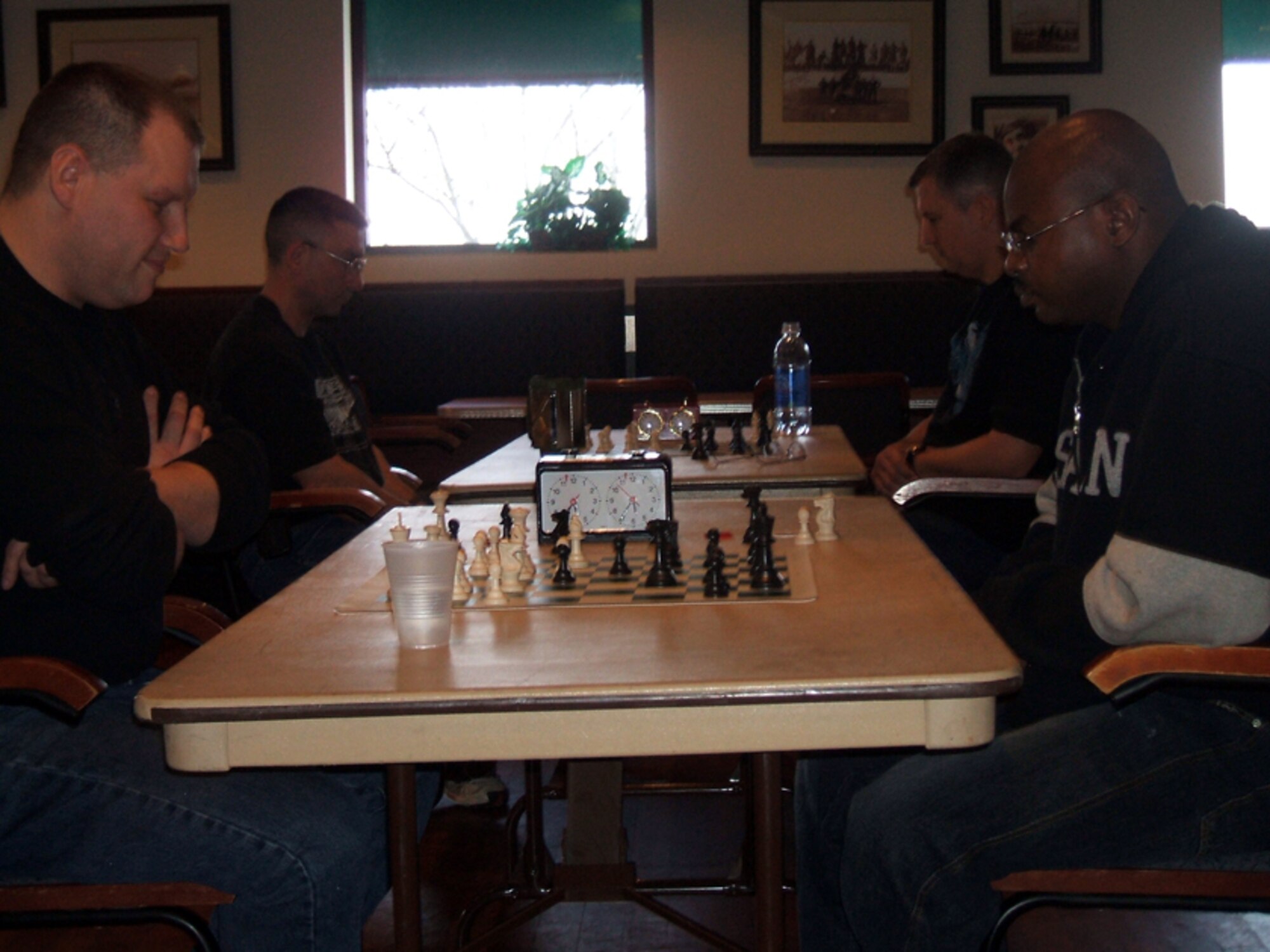 McGuire members participate in the 2009 McGuire Base Chess Championship, hosted by the 87th Services Squadron, March 7 at The Club. Front left, Tech. Sgt. John Scull, 305th Maintenance Squadron, who won the overall event, plays Tech. Sgt. Lamont Stanton, 305th Aircraft Maintenance Squadron, and back left, Maj. Andrew Phillips, 305th Maintenance Operations Squadron, plays Senior Master Sgt. Phil Gaudette, 305th Aerial Port Squadron and tournament director. Another chess championship will be held next year. (U.S. Air Force courtesy photo) 