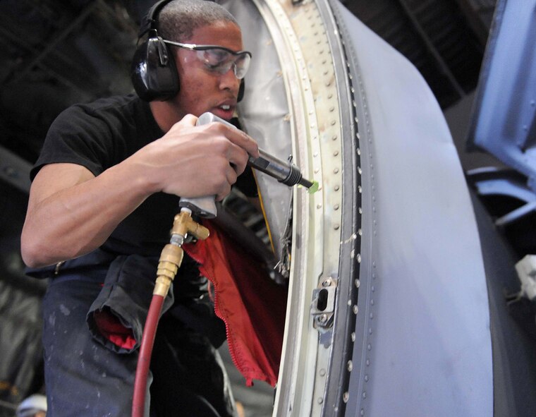 DYESS AIR FORCE BASE, TX-- Airman First Class D'Jon Green uses a rivet hammer to place rivets into a C-130 here Mar 17. A1C Green is apart of a team of maintainers repairing a C-130 for ISO inspection (U.S. Air Force photo by Senior Airman Domonique Simmons)