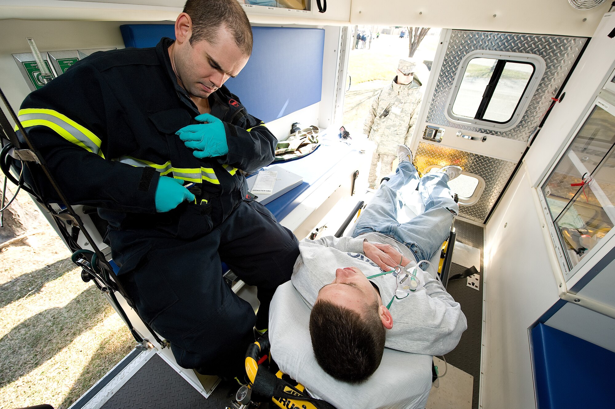 (Left to right) Airman 1st Class Jacob Porter, 436th Medical Support Squadron aerospace medical technician, responds to a simulated asthma attack by Airman 1st Class Colten Atwood, 436th Medical Operations Squadron, as part of the Major Accident Response Exercise March 12. (U.S. Air Force photo/ Jason Minto)