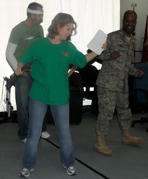 Master Sgt. Melanie Adams, American Forces Network Incirlik and Staff Sgt. Matthew Lichtenburg, AFN, taught 39th Air Base Command Chief Robert Ellis to do the “cupid shuffle” for his challenge while he was “jailed” during the Air Force Assistance Fund telethon March 17 at Incirlik Air Base, Turkey. The AFAF telethon hosted a “Jail’n’Bail” where money was donated for “suspects” to be thrown in jail.  A dollar bought a minute of time with a minimum of a $30 bid for “suspects” to sit in jail and perform live challenges. The telethon raised more than $5,000 for the AFAF. (U.S. Air Force photo/Airman 1st Class Amber Russell)