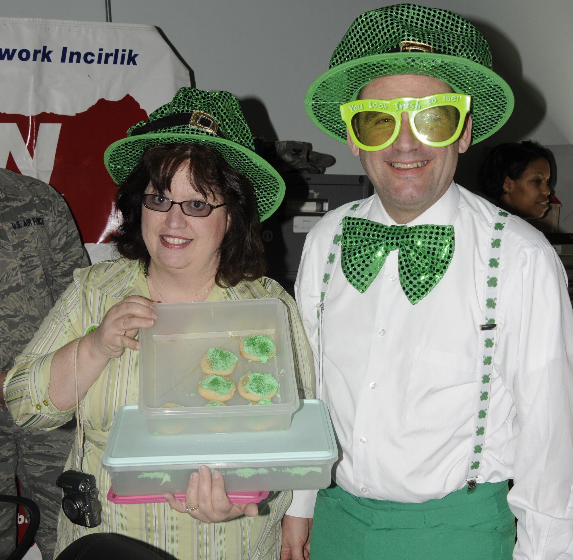 Col. Andrew Pears , 39th Mission Support Group commander and his wife, Mary, dressed to celebrate St. Patrick’s Day, brought cupcakes to cheer up the individual’s in the “Jail’n’Bail” during the Air Force Assistance Fund telethon March 17 at Incirlik Air Base, Turkey.  American Forces Network Incirlik hosted the telethon to help raise more than $5,000 in proceeds to be donated to the AFAF. During the telethon, donations were made by members of Incirlik to send individuals to the “jail” or to request songs over the radio to be played. (U.S. Air Force photo/Airman 1st Class Amber Russell)