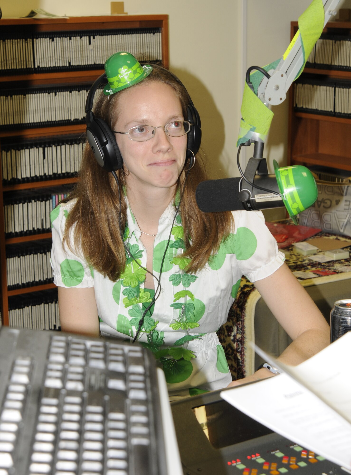 Dressed to celebrate St. Patrick’s Day, Senior Airman Jennifer Stai, American Forces Network Incirlik, assists in hosting the Air Force Assistance Fund Telethon March 17 during the live broadcast at Incirlik Air Base, Turkey. AFN hosted the telethon and raised more than $5,000.  Donations were made by members of Incirlik to send individuals to the “Jail’n’Bail” and to request songs over the radio to be played.  Song requests were a dollar, while two dollars or more bought a different song to “bump” the original. (U.S. Air Force photo/Airman 1st Class Amber Russell)