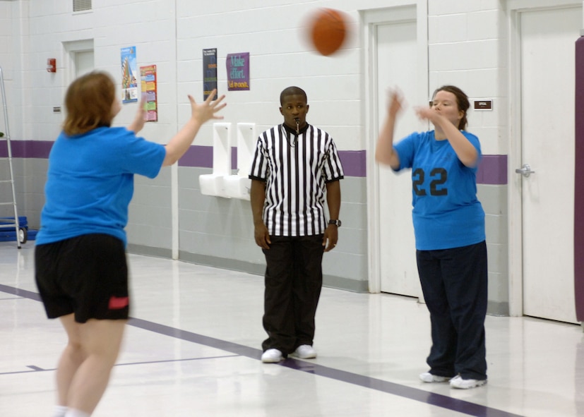 MINOT, N.D. -- Senior Airman Anthony Moore, 91st Missile Security Forces Squadron, referees a game during the Minot Special Olympics district basketball tournament at Bishop Ryan High School here March 13.  Airman Moore and other members from the base community provided volunteer support for the tournament.  (U.S. Air Force photo by Senior Airman Sharida Jackson)