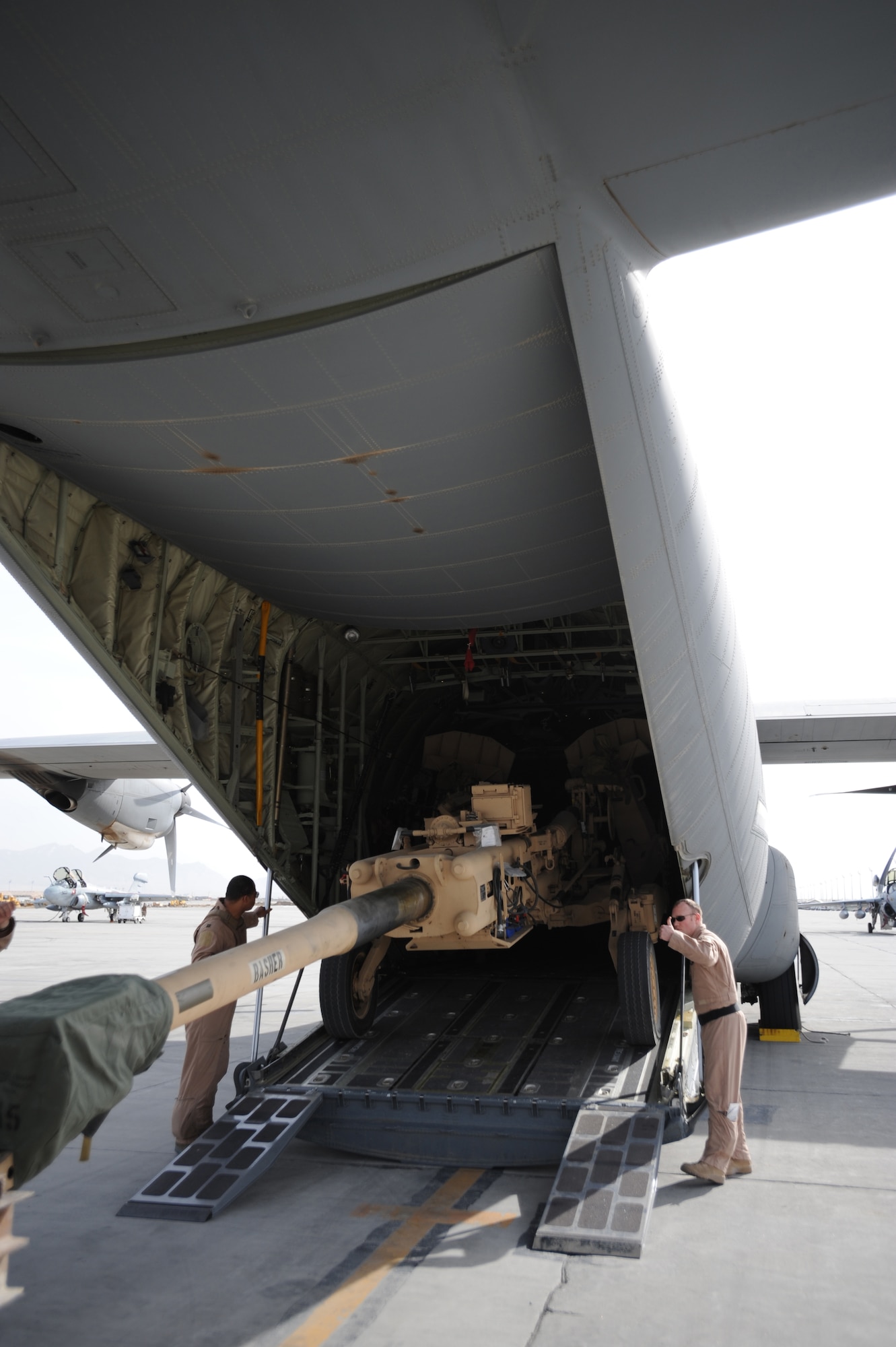 Aircrew load an M777 A2 Howitzer onto a U.S. Air Force C-130J Hercules at Bagram, Afghanistan, March 14, 2009.  The C-130J is part of the newly assigned 772nd Expeditionary Airlift Squadron, Kandahar Air Field, Afghanistan, that has been set up to assist with the increase of U.S. Troops to the region.  (U.S. Air Force photo by Staff Sgt. James L. Harper Jr.)