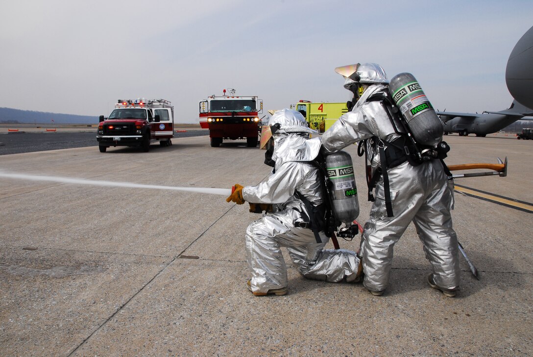 Fire fighters from the 193rd Special Operations Wing Pa. Air National Guard's Fire Crash Stations release water during a training exercise at the Harrisburg International Airport Middletown, Pa. March 14, 2009.  The Fire Station is responsable for protecting the aircraft, buildings and airmen of the 193rd SOW.