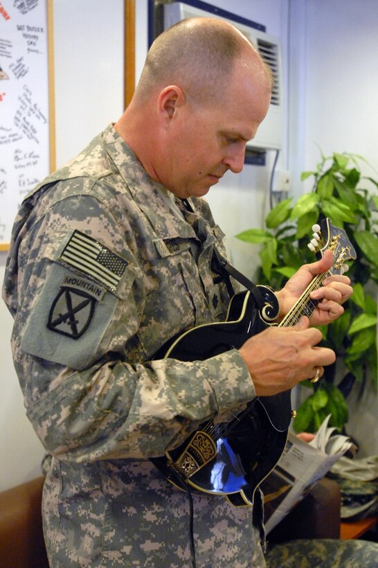 Army Chaplain (Lt. Col.) Mike Charles plays the mandolin during a song with the Baghdad Bad Boys, which played for the final time together in Iraq on March 15, 2009, at the Green Beans coffee shop on Camp Victory. The group has plans for a reunion show in Fayetteville, N.C. U.S. Army photo by Spc. Darryl Montgomery