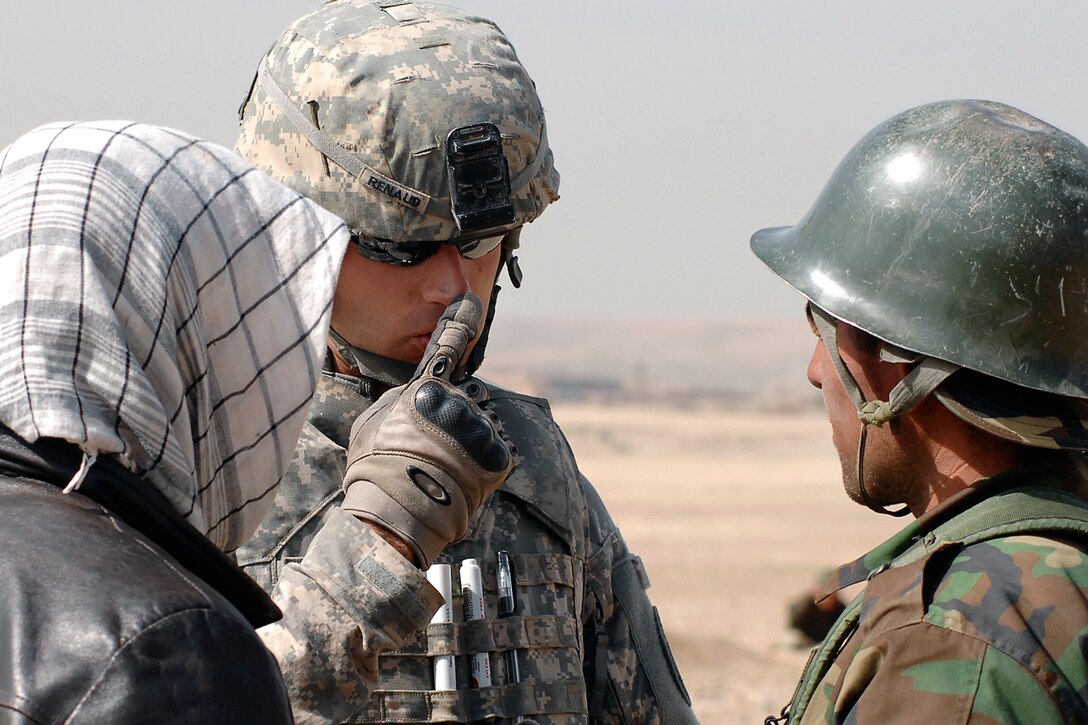 U.S. Army Staff Sgt. Derek Renaud offers some tips to an Afghan national army soldier trying to zero in his weapon on the Kabul Military Training Center, Afghanistan, March 17, 2009. Renaud is assigned to Camp Alamo Mentor Group's Basic Warrior Training Branch. He is also in charge of the range and mentors Afghan recruits as they learn to use their new M16s.