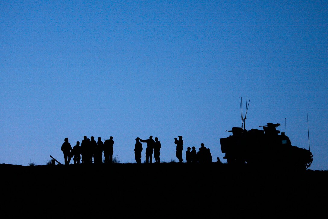 U.S. Army soldiers and Afghan National Army Commandos take a moment to relax and discuss the day's events before preparing for a night operation in the Khowst province, Afghanistan, March 13, 2009.