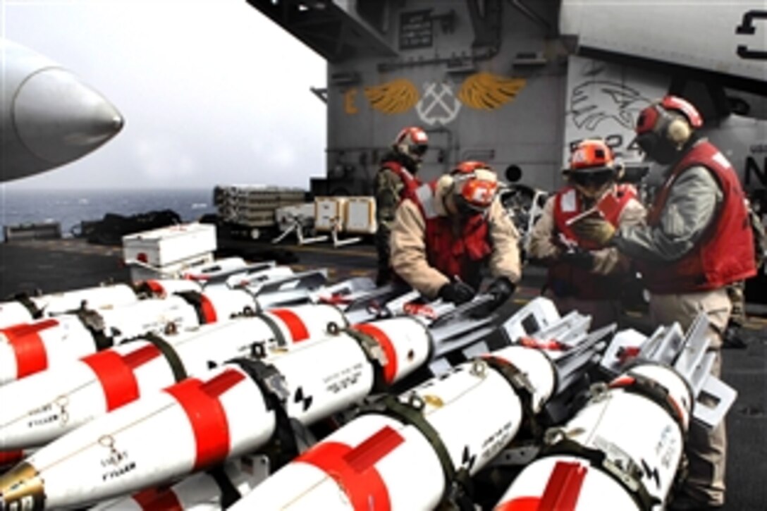 U.S. Navy crew inspect MK-62 mines on the flight deck of the aircraft carrier USS John C. Stennis to prepare for loading onto aircraft as part of Exercise Foal Eagle 2009 in the Pacific Ocean, March 16, 2009. Foal Eagle is a defense-oriented annual training exercise with the Republic of Korea demonstrating U.S. commitment to regional peace and stability.