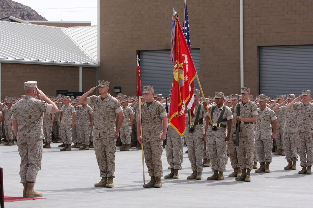 1st Lt. Brett Nungesser, the Company E commander, 3rd Light Armored Reconnaissance Battalion, salutes Lt. Col. Ken Kassner, the commander of 3rd LAR, before revealing their guideon during the company's activation ceremony March 19 at the battalion's Light Armored Vehical ramp. Company E.